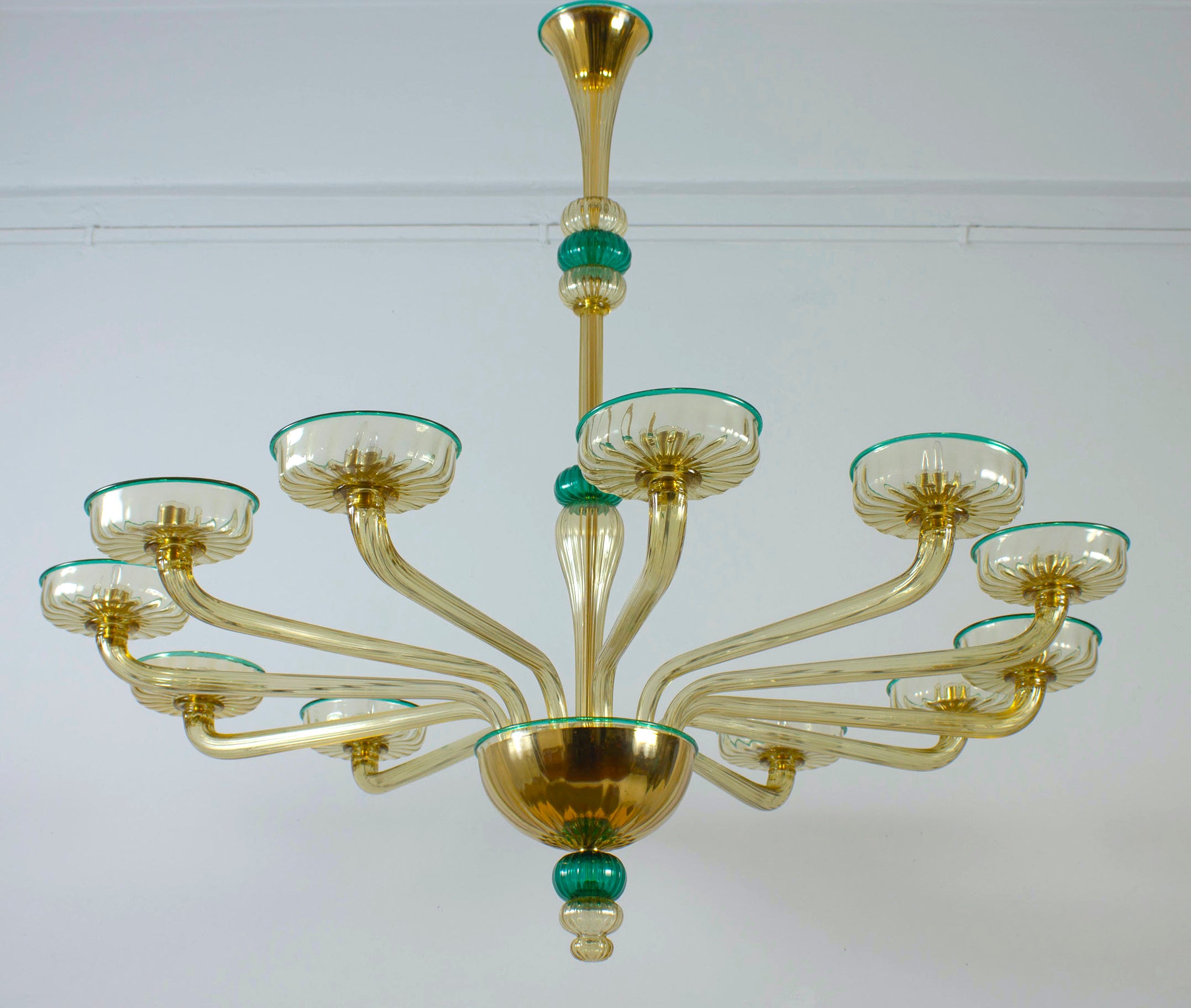 This magnificent amber color  chandelier  features 12 arms with emerald color finishes. 

Cleaned and re-wired, in full working order and ready to use. In excellent vintage condition. The  glasses, all original and in good condition, are without