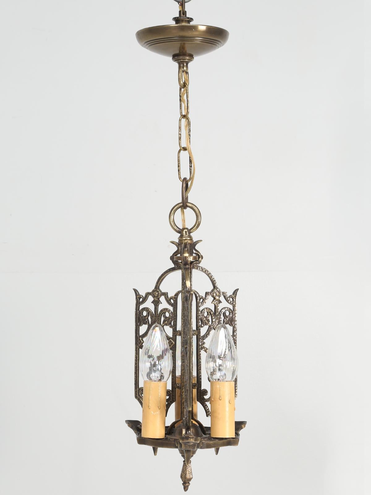 Chandelier, probably manufactured in America, of solid brass and is quite heavy for its size. This was recently removed from a home in the Arts & Craft style, blended with Greek revival. Although the home was built in 1908, we have no idea when the