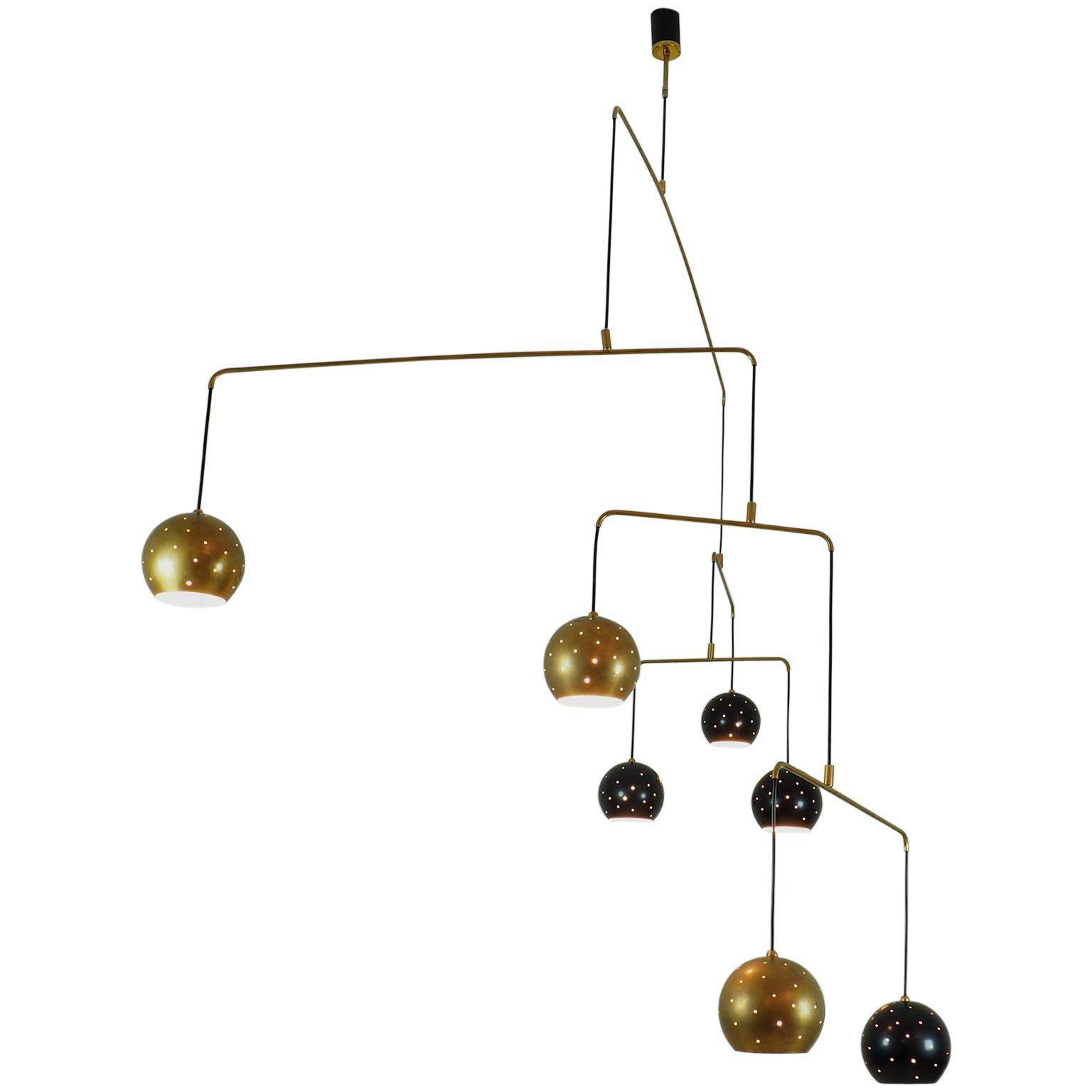 Original Italian brass mobile chandelier manufactured in a very 7 small handcraft production in Milano, 20th century
Large, magic and poetical mobile chandelier with brass and black suspending spheres, it can moves with the flow of air.
Wholly in