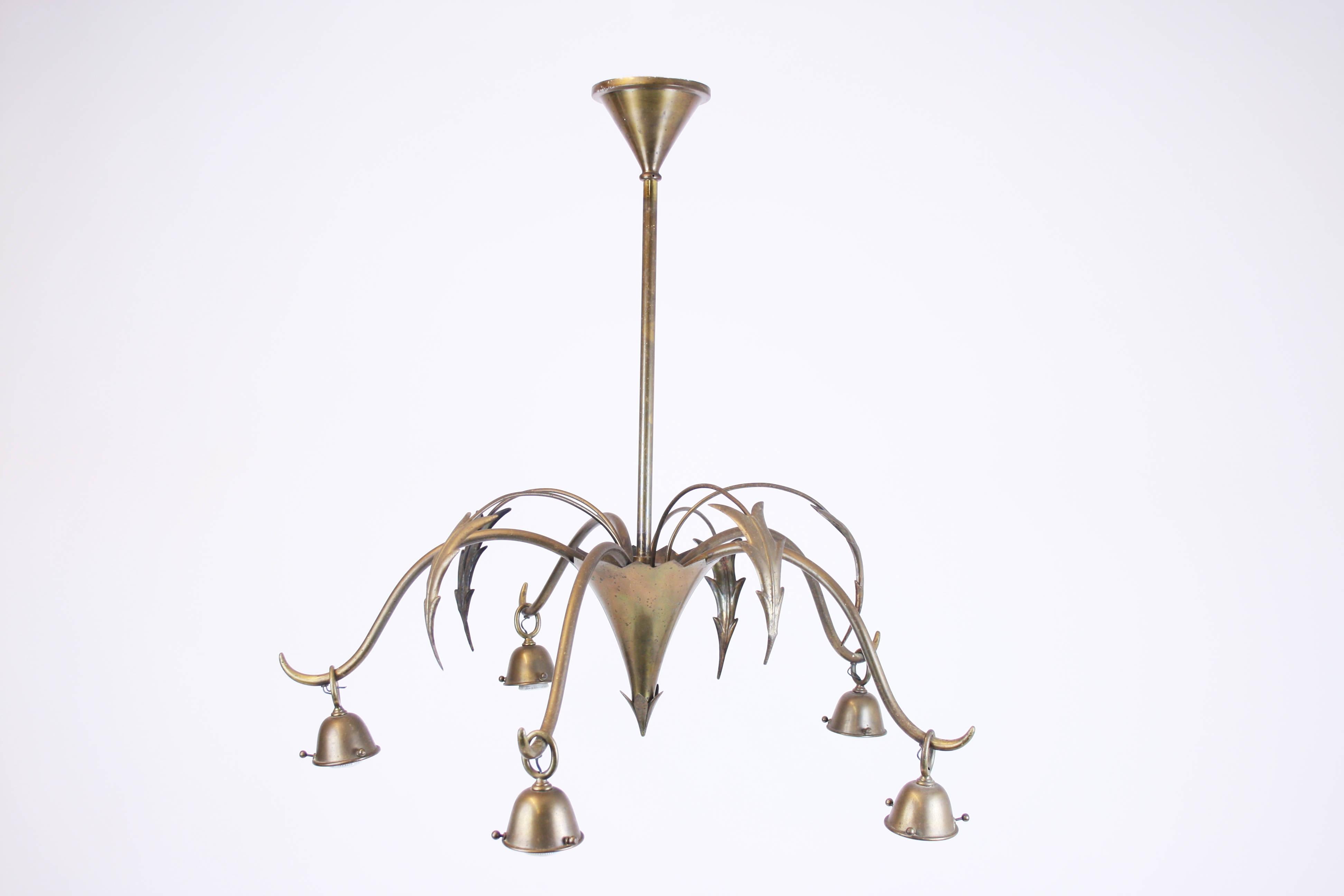 Chandelier of solid brass in the manner of Dagobert Peche and Wiener Werkstätte, Austria around 1910. It impressively shows how various new signs and languages of form were sought and tried out during this period. This avant-garde object has 5 bulbs
