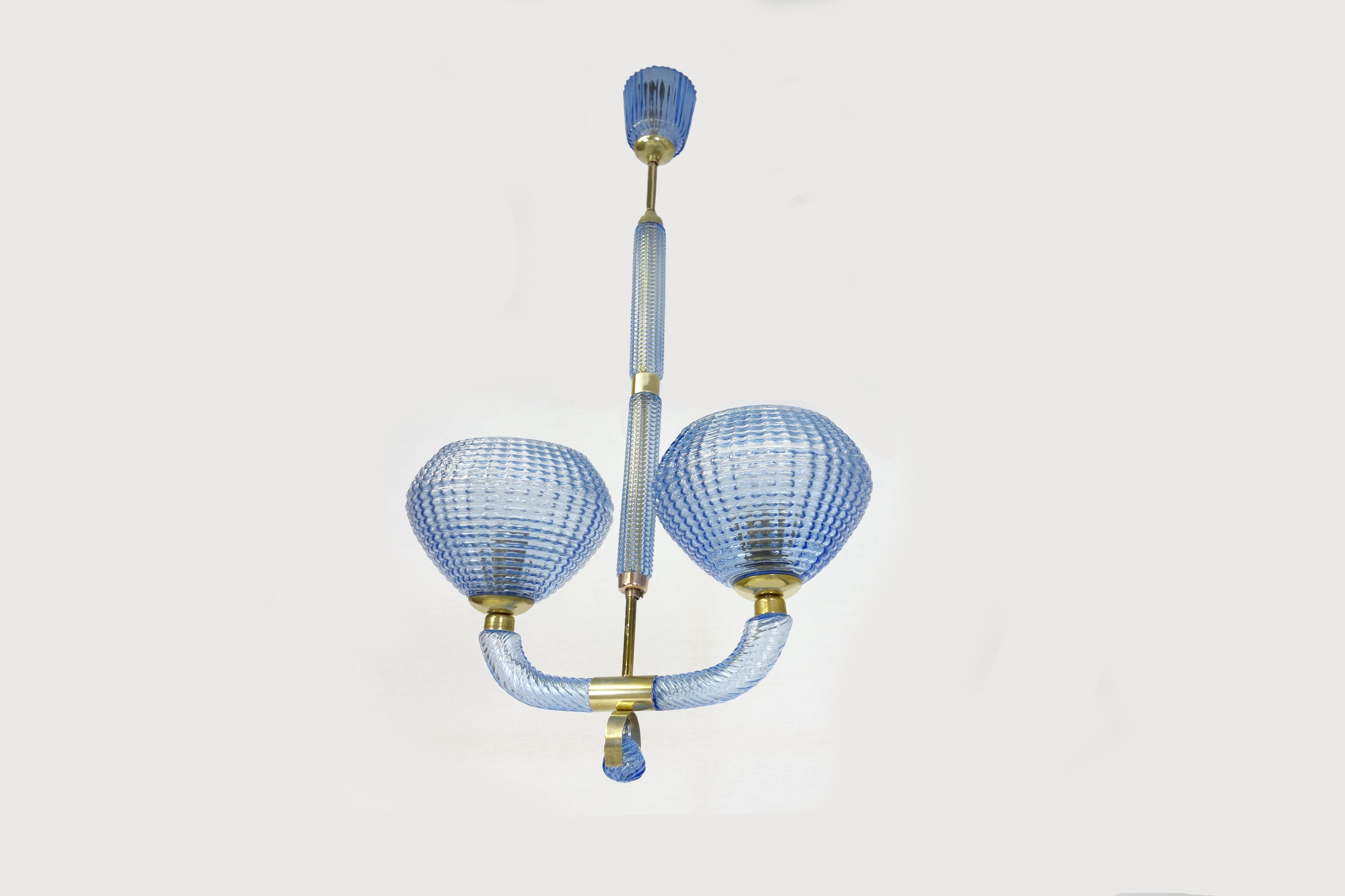 An extremely attractive blue 2-arm chandelier with numerous playful details is offered by this original from the Venetians Barovier & Toso manufactured in Italy in the 1940s. The blue Murano glass ensemble shows fine cut cannelures extending over