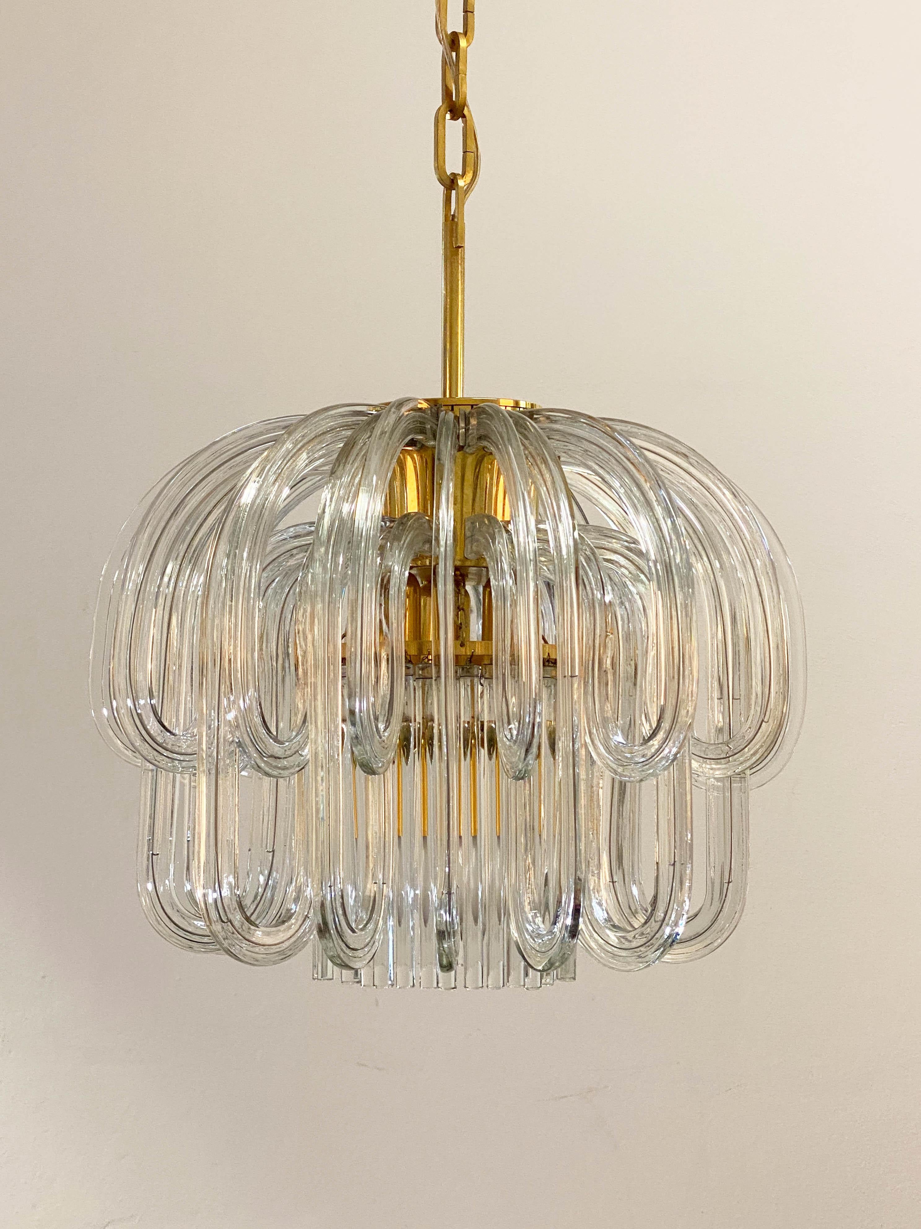 Brass/glass chandelier, 1965, designed by Cari Zalloni (1937-2012), graduate of the master class for the Design Academy for Applied Arts under Professor Oswald Haerdtl. Brass frame, circle made of solid glass rods, glass arches hung all around.