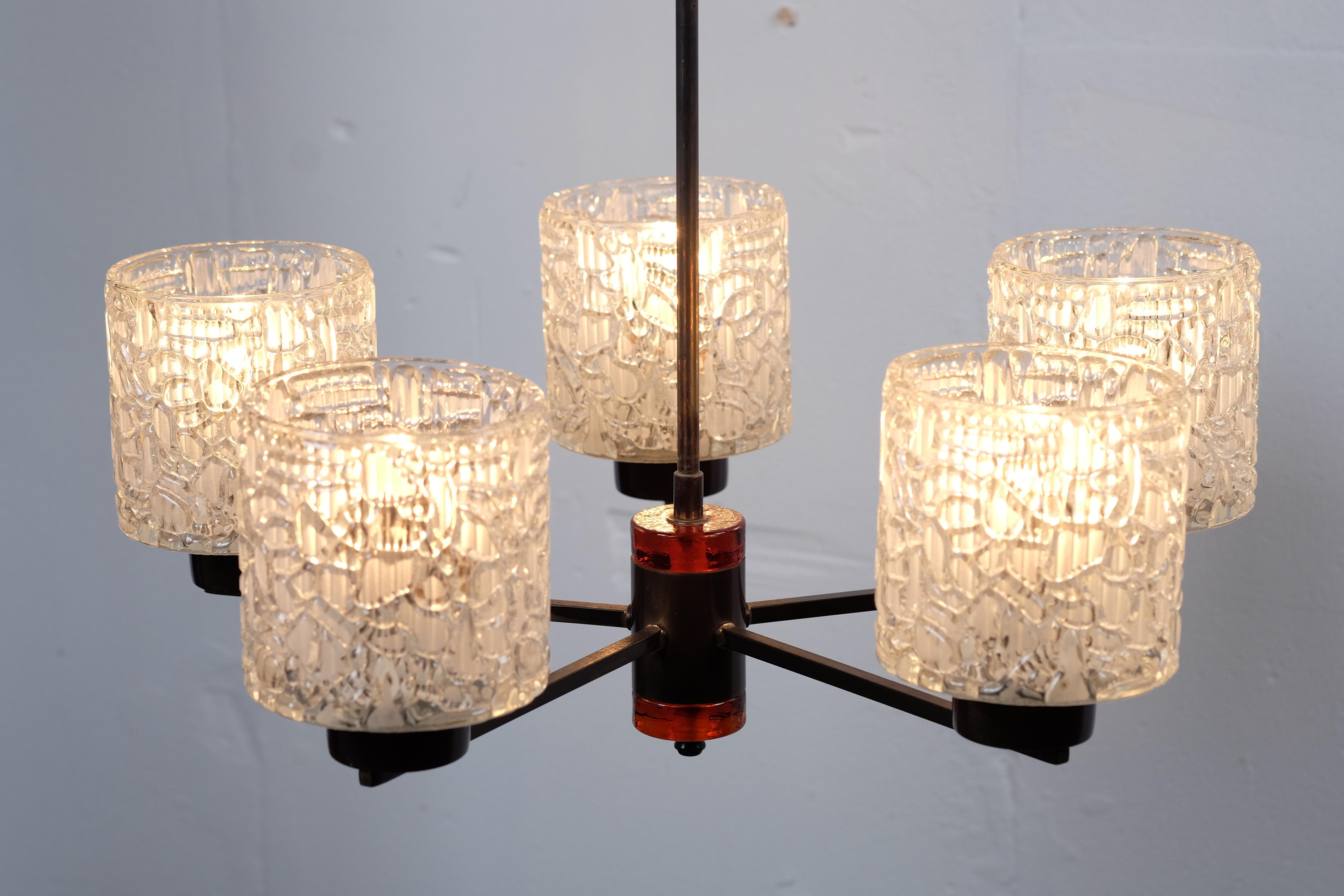 Orrefors of Sweden 6-arm light chandelier in pressed and frosted glass by Carl Fagerlund, with brass and amber glass fitments.
The lamp are in good condition and with no chips or damage in the glass. 

The diameter of each glass is