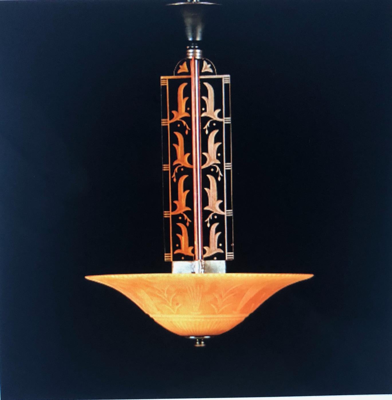 Rare chandelier by Edward Hald, Orrefors, 1930s. Clear Rio brown glass   plate and four glass pillars in light-brown glass with engraved and blasted geometric décor. 
Height 85, diameter 51cm. Rewiring available upon request.
Literature Brilliance