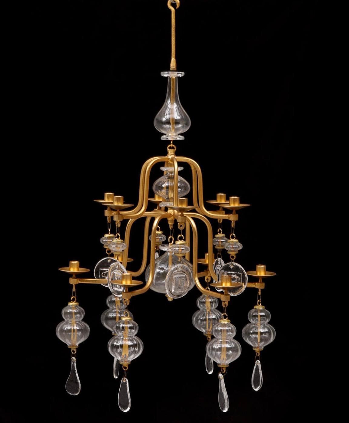 A gilt wrought iron and glass chandelier by Erik Hoglund for Boda. 12 arms.

Circa late 20th century.

Electrification available upon request. H 40″ D 21″.