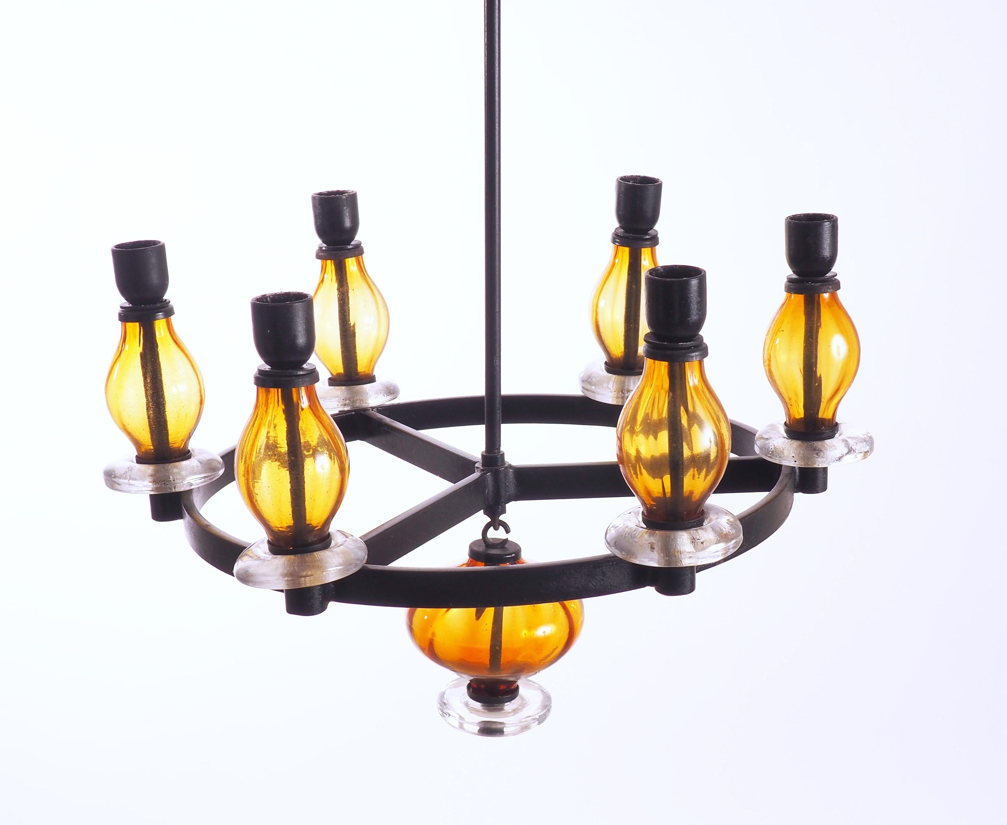 Chandelier by the Swedish glass artist Erik Höglund for Boda Glassworks in iron and amber colored glas. This chandelier holds six candles. Extra extensions are included.