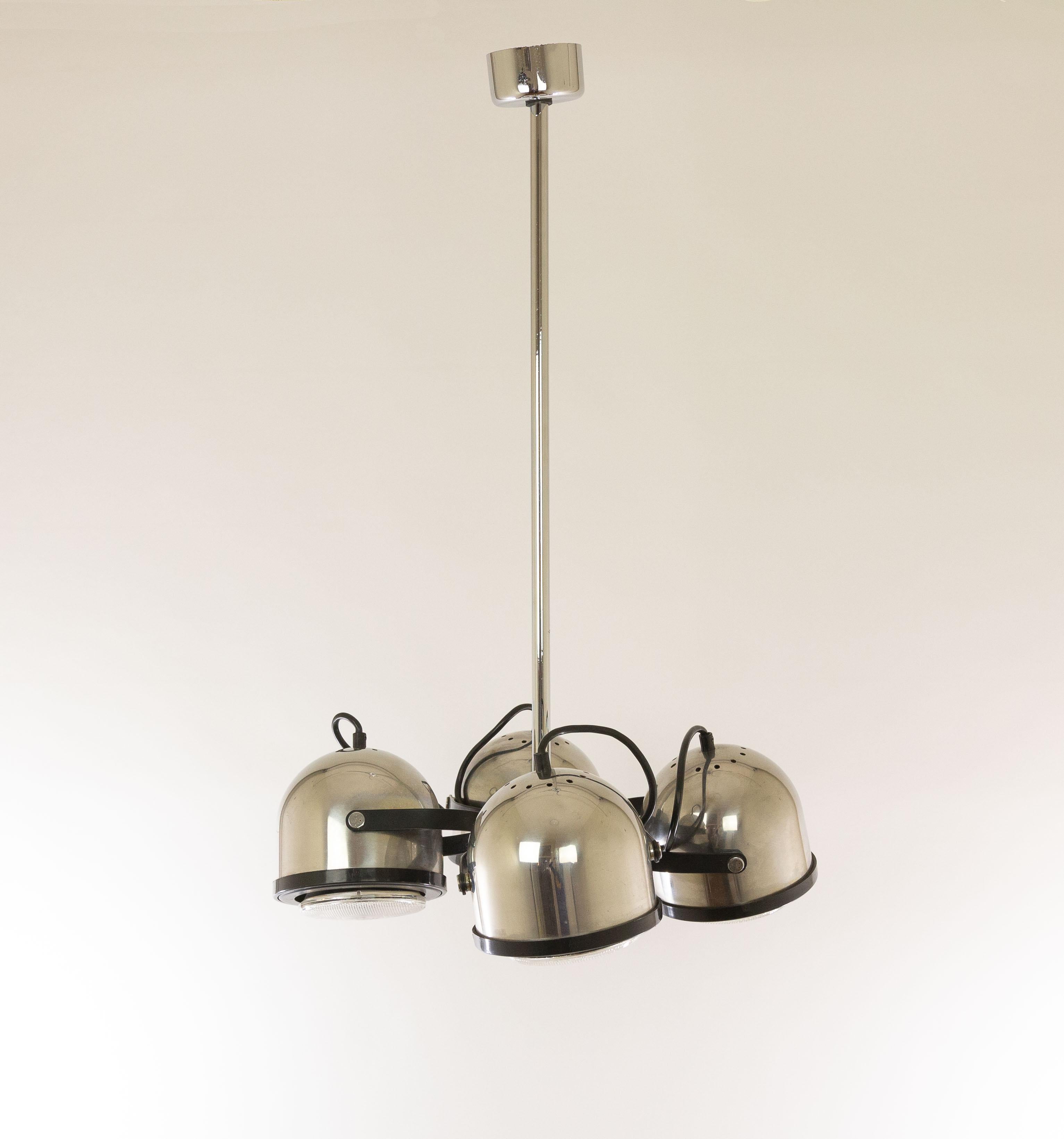 Chandelier with four swiveling spots made of chromed metal designed by Gae Aulenti and Livio Castiglioni for Stilnovo in the 1970s.

As described in a catalogue by Stilnovo this model, 6205, has been designed by Gae Aulenti and Livio Castiglioni