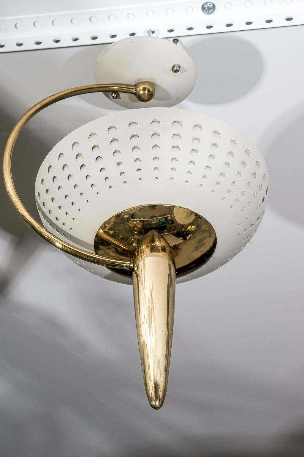 This stylish chandelier dates to the 1960s and was created for Lightolier by Gerald Thurston.

The perforated form catches the light beautifully.

Note: Requires one Edison based light bulb

Note: Oxodation to the brass finish (see images).

Note: