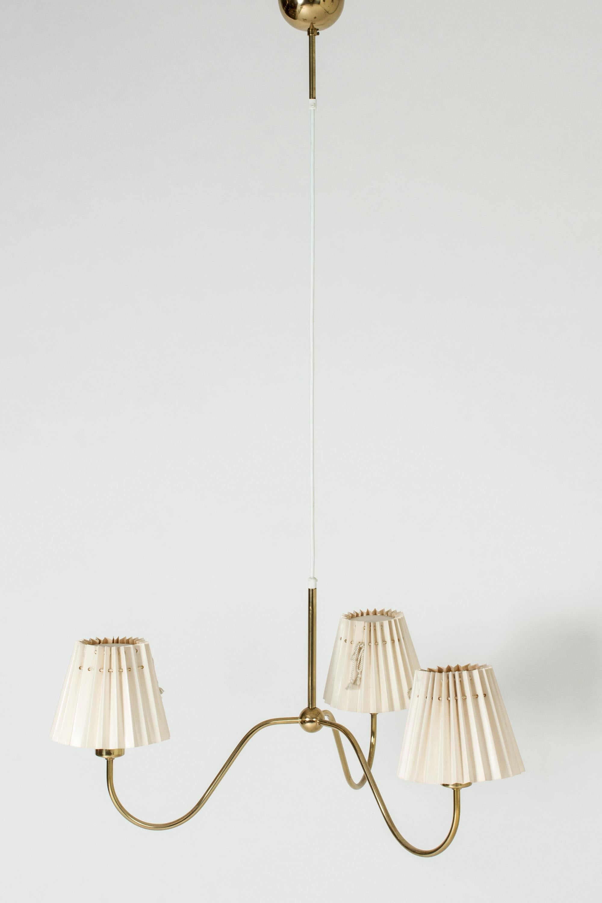 Three-armed chandelier by Josef Frank, made from brass. Wide, elegant design with a decorative ball at the center of the undulating arms. Original shades in good condition.