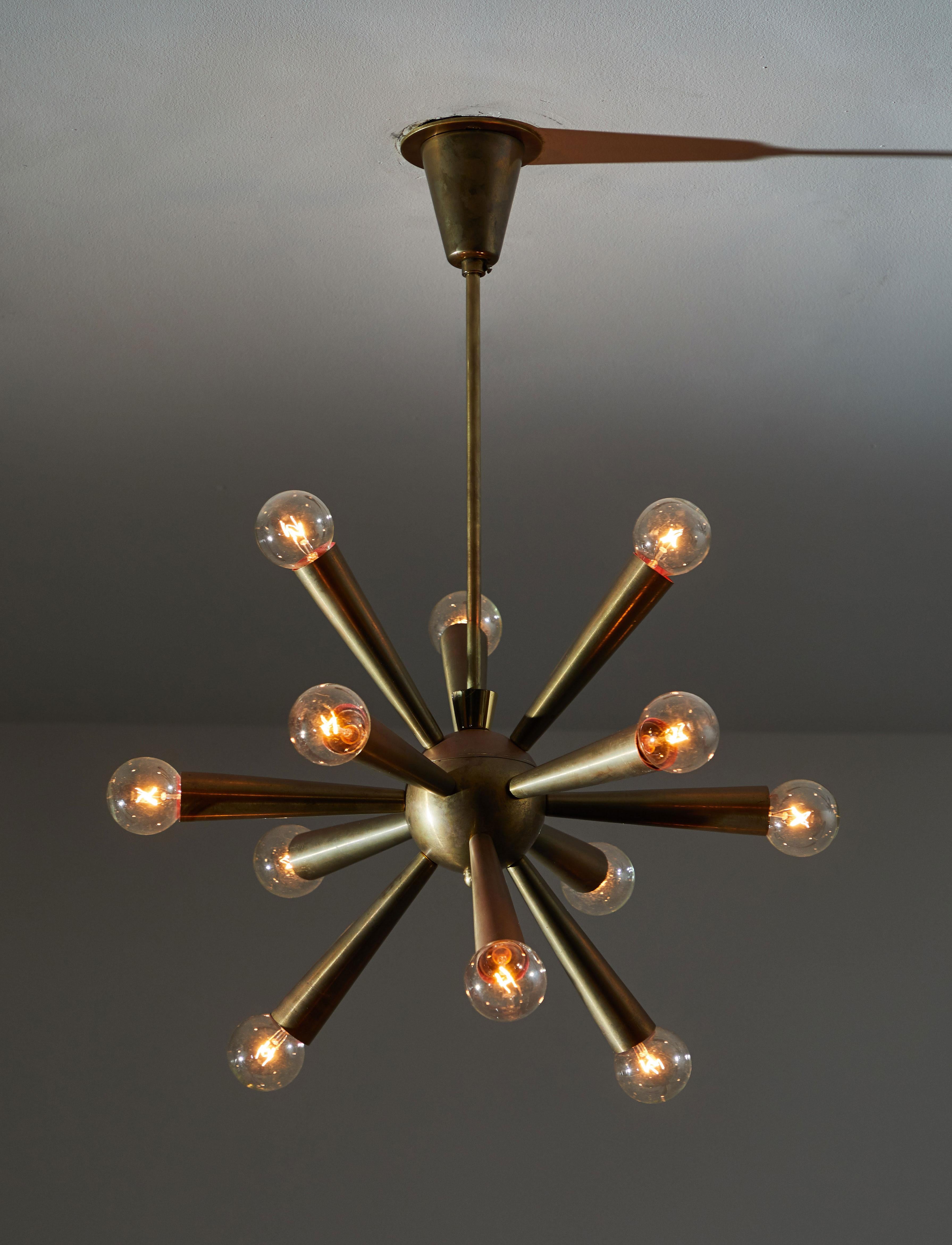 Chandelier manufactured in Austria, circa 1950s. Brass with original canopy and brass ceiling plate. Rewired for US junction boxes. Takes twelve European candelabra 40w maximum bulbs. Height displayed is from canopy to bottom of fixture.