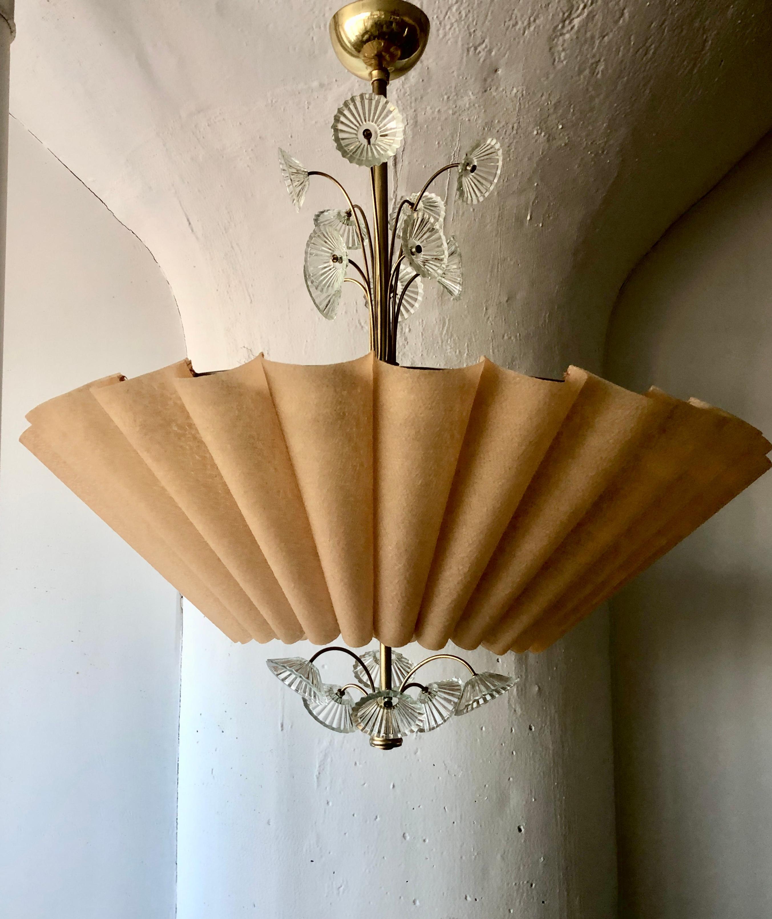 A Chandelier designed by Lisa Johansson-Pape for Orno, Finland . Circa 1950th. The glass flowers decorations on the stem and a pleated, faux parchment shade. (3) Edison style sockets.
Rewiring as per customer specification available upon request.