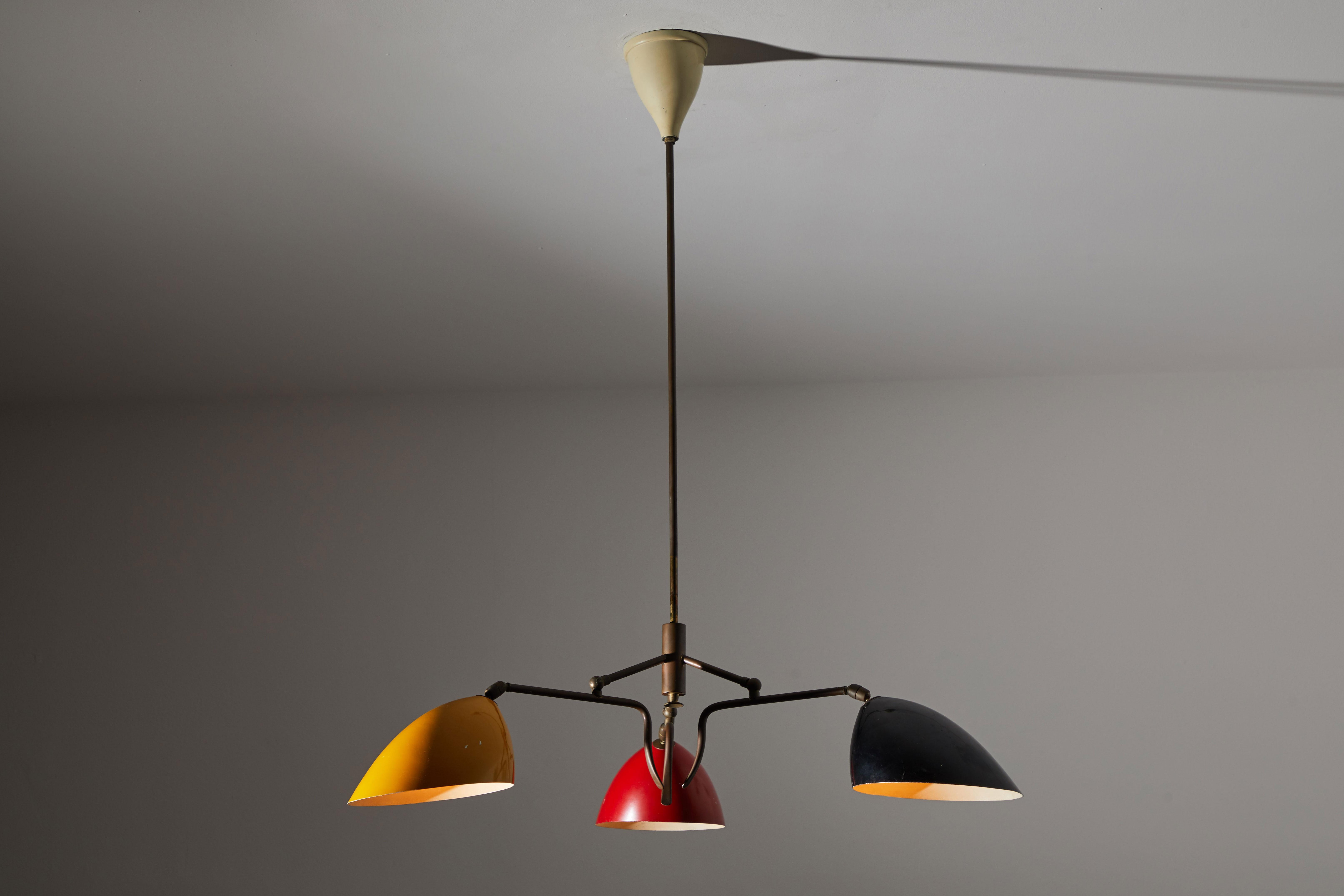 Three-arm chandelier by Lumen. Manufactured in Italy, circa 1950s. Brass and enameled metal. Shades articulate in various positions. Rewired for US junction boxes. Original canopy. Takes three E27 60w maximum bulbs.