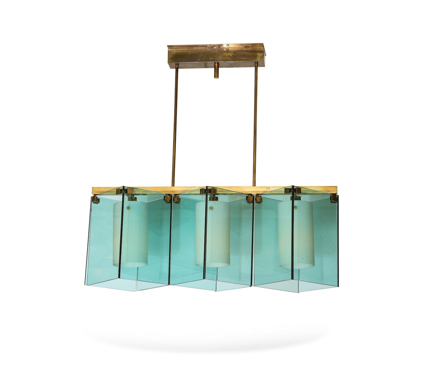 Chandelier #2128 by Max Ingrand for Fontana Arte. Fantastic 3 light fixture featuring thick slabs of aqua-marine glass, with frosted glass cylinder shades and polished brass mounts. Each frosted cylinder conceals a standard Edison socket. Published: