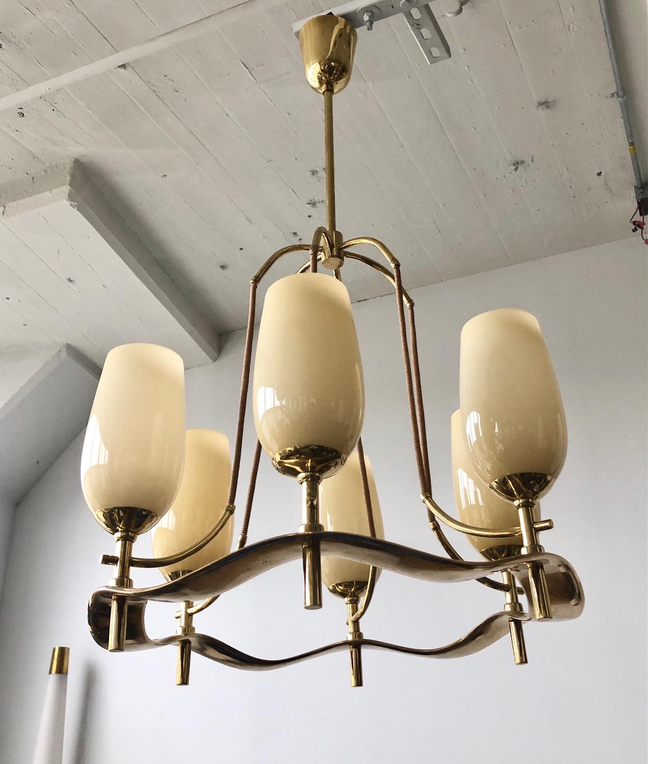 Custom order chandelier designed by Pave Tynell for Taito Oy, Finland, circa 1940s.
Waved cast brass ring with 6 opaline glass shades lights. Marked Taito.
Rewiring available upon request.