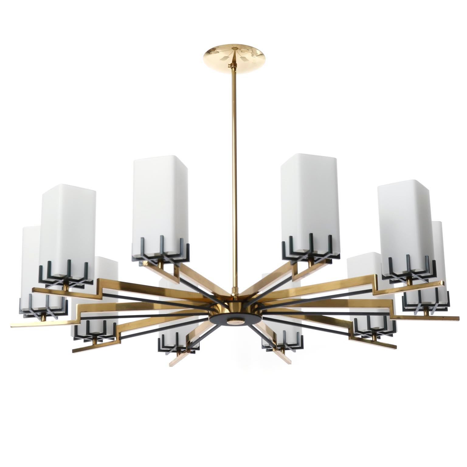 A large 8-arm chandelier manufactured by Rupert Nikoll, Austria, Vienna, in midcentury, crica 1960 (late 1950s or early 1960s).
The lamp consists of a solid and polished brass frame with black or anthracite-colored details and square glass tubes as