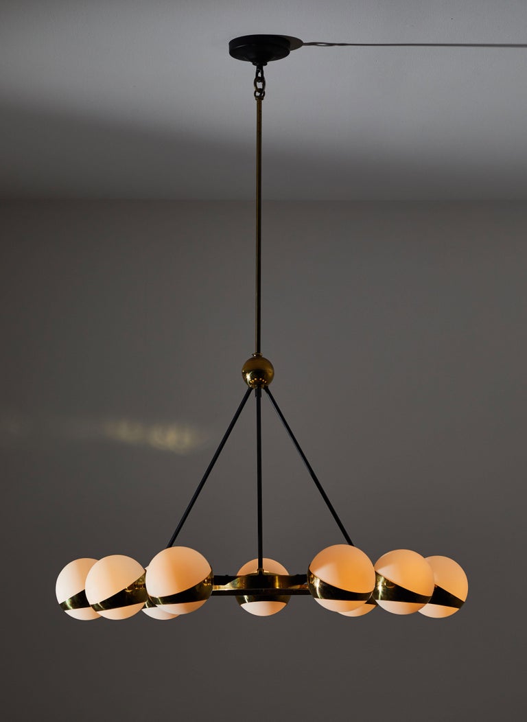 Nine Globe chandelier by Stilnovo. Manufactured in Italy circa 1950s. Brass, with brushed satin glass diffusers. Rewired for US junction boxes. Each globe takes one E26 25w maximum European candelabra bulbs. Bulbs provided as a one time courtesy.