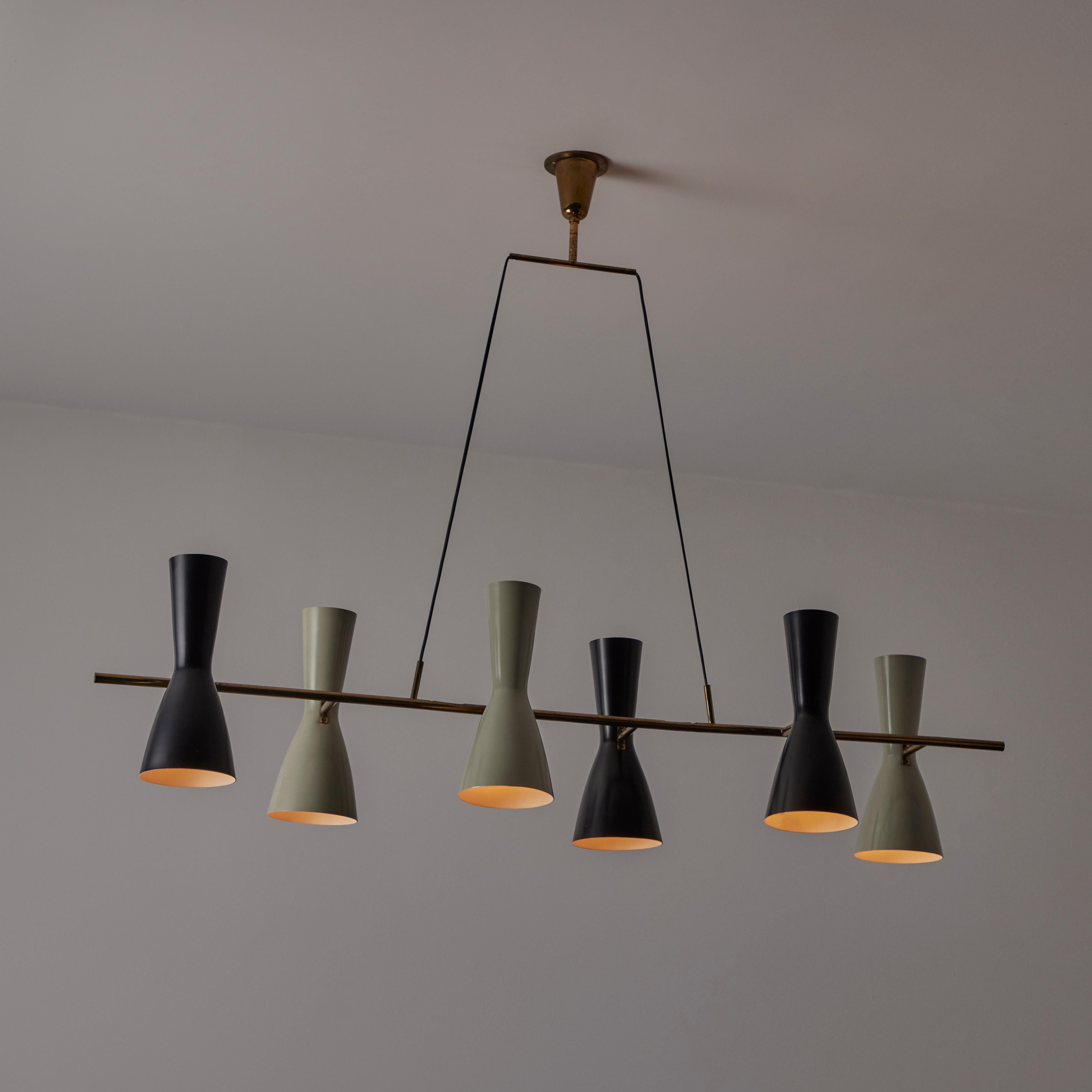 Linear chandelier by Stilnovo. Manufactured in Italy, circa the 1950s. Six double fluted shades run in a sequential pattern down a linear brass suspension rod. The shades are sequenced as two colorways; a greyish olive tone, and a black tone. Shades
