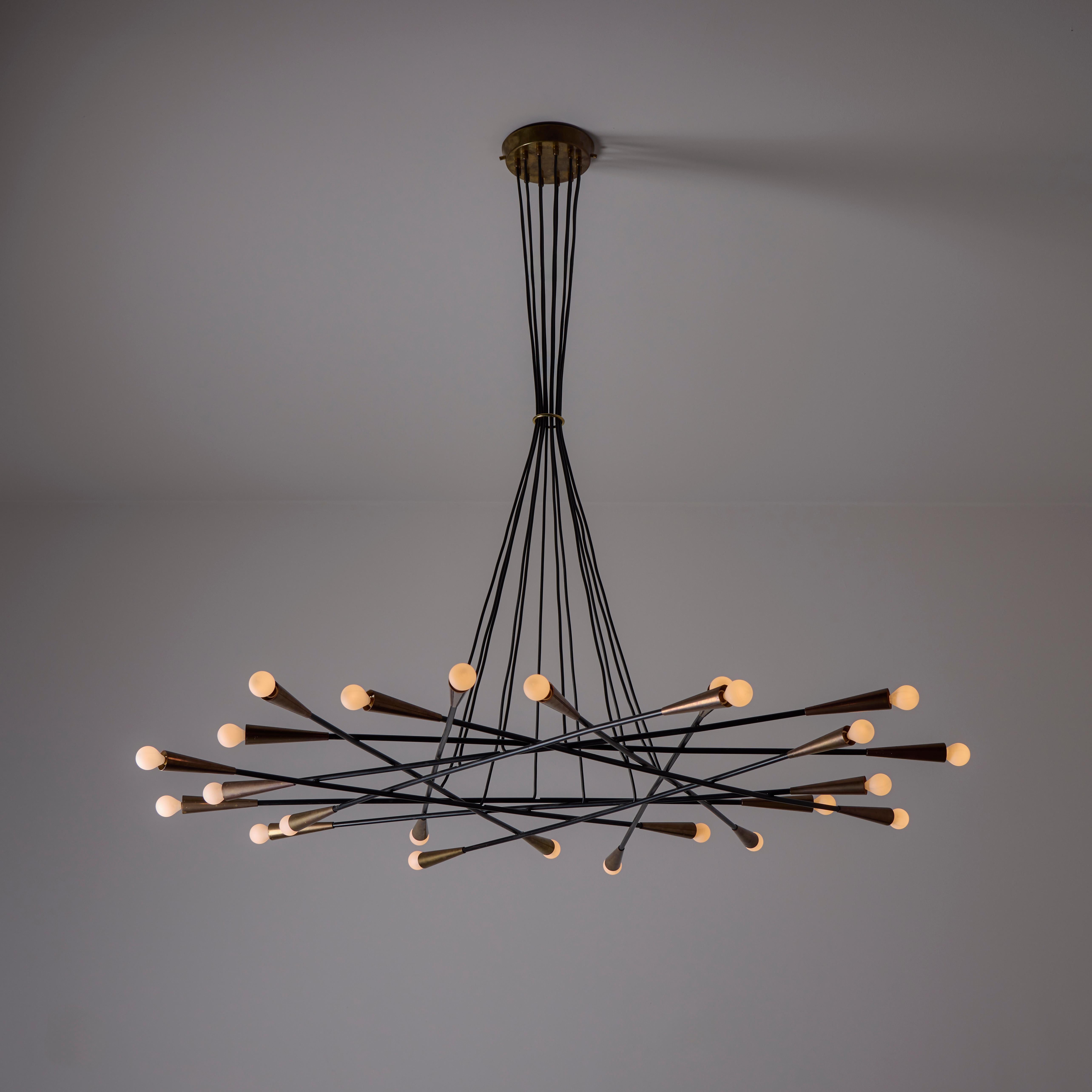 Multi-armed flat chandelier with aged brass socket coverings. Height adjustable. Holds twenty-four E14 socket types, adapated for the US. We recommend 25w max bulbs or LED equivalents.