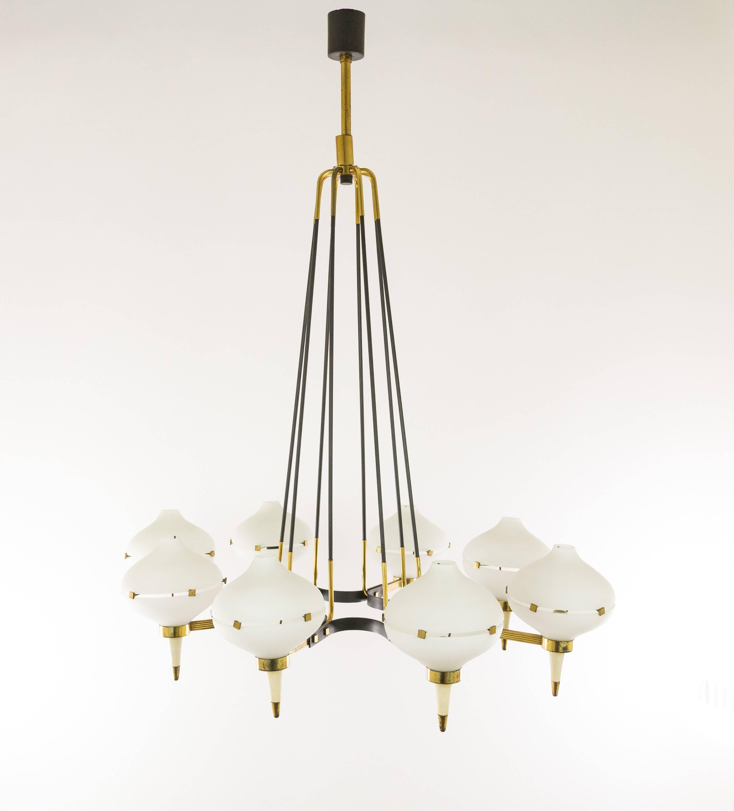 Remarkable Italian 1950s chandelier, attributed to Stilnovo. The frame of the lamp is made of metal and brass. The eight opal glass cups consist each of two parts, elegantly held together by a brass construction.

The lamp is in good original