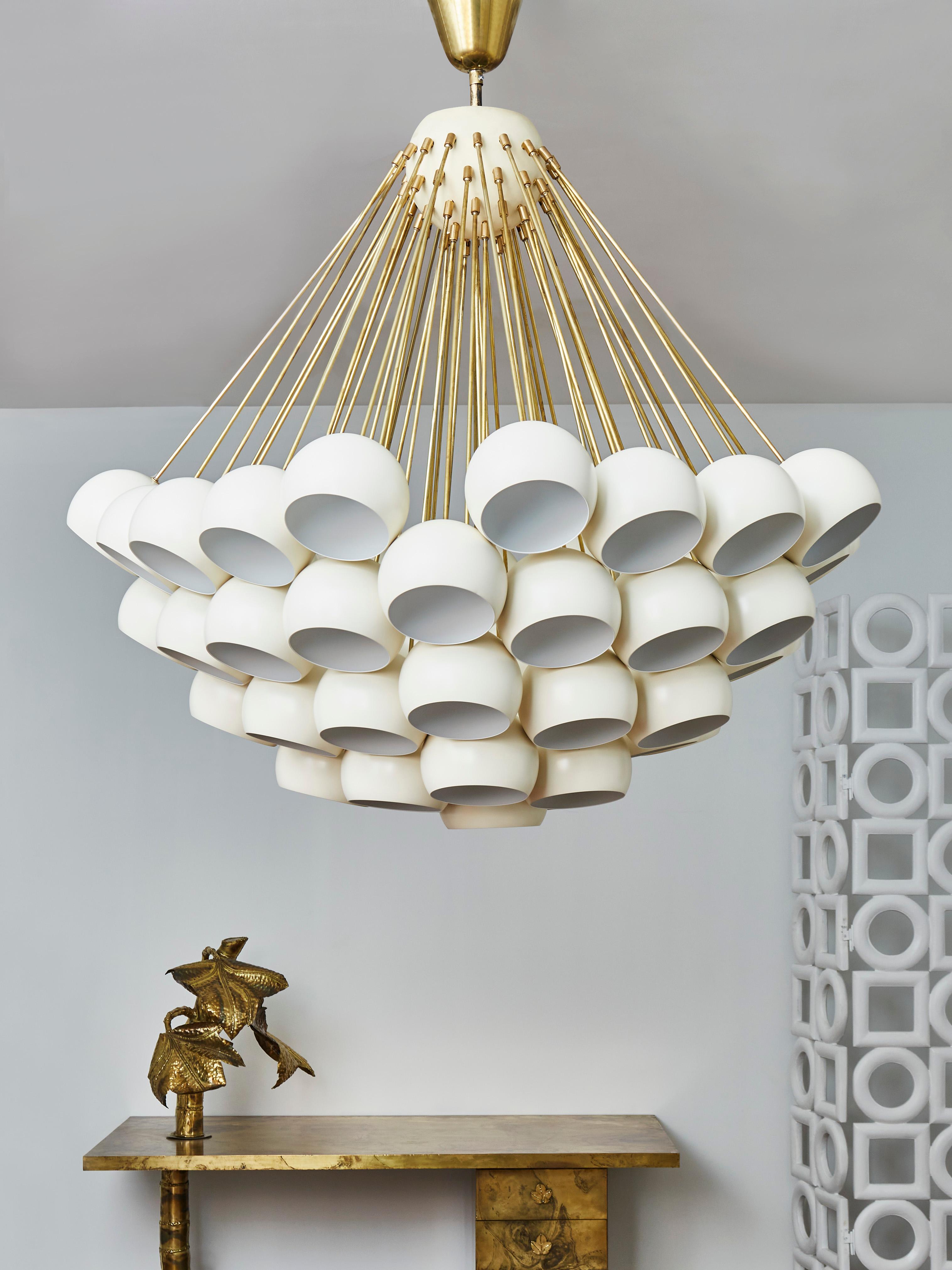 Important chandelier in brass with lacquered sheet metal globes. 
Creation by Studio Glustin.
  