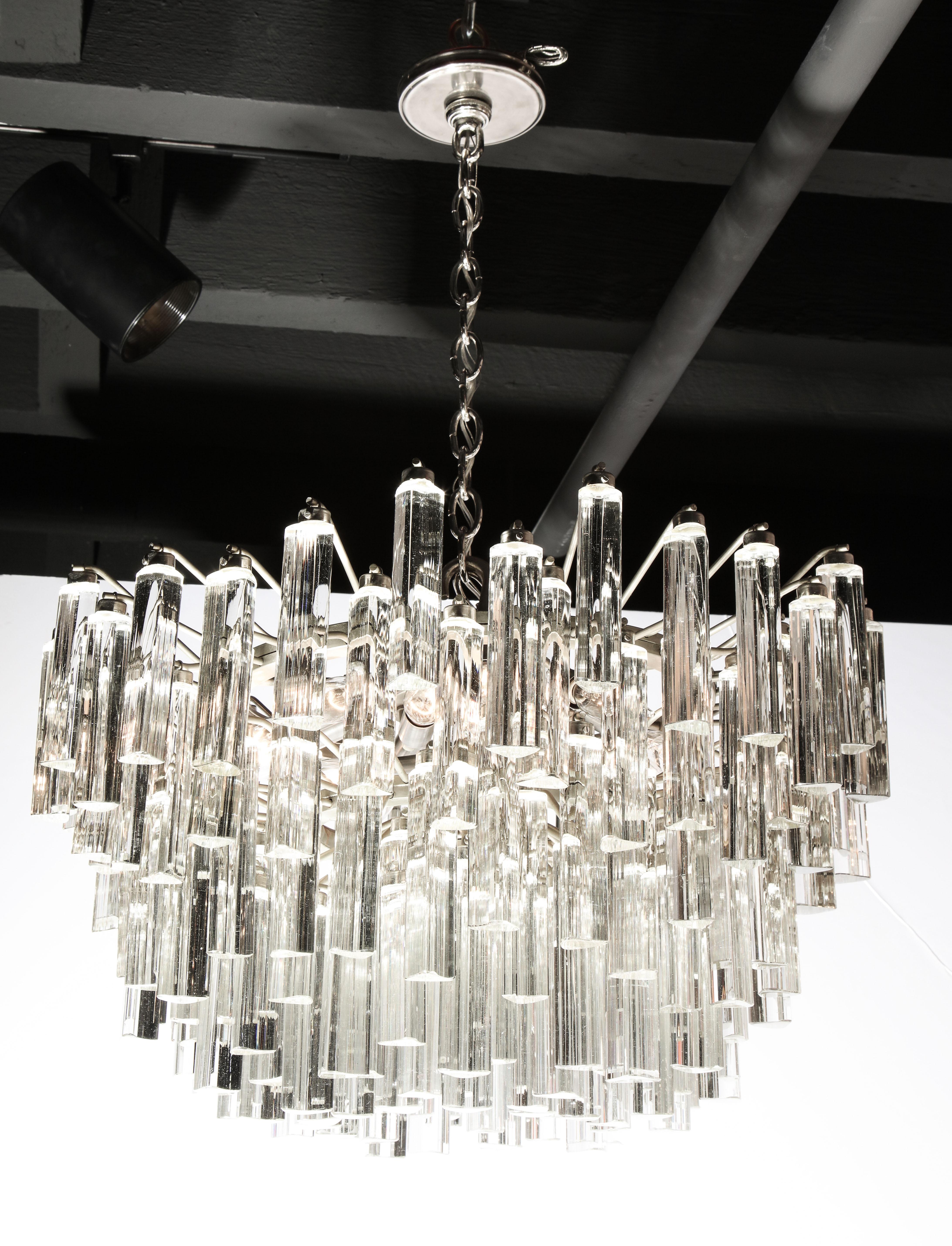 Decorative glass chandelier, circa 1950. Frame and details on the glass pieces are made of chrome.