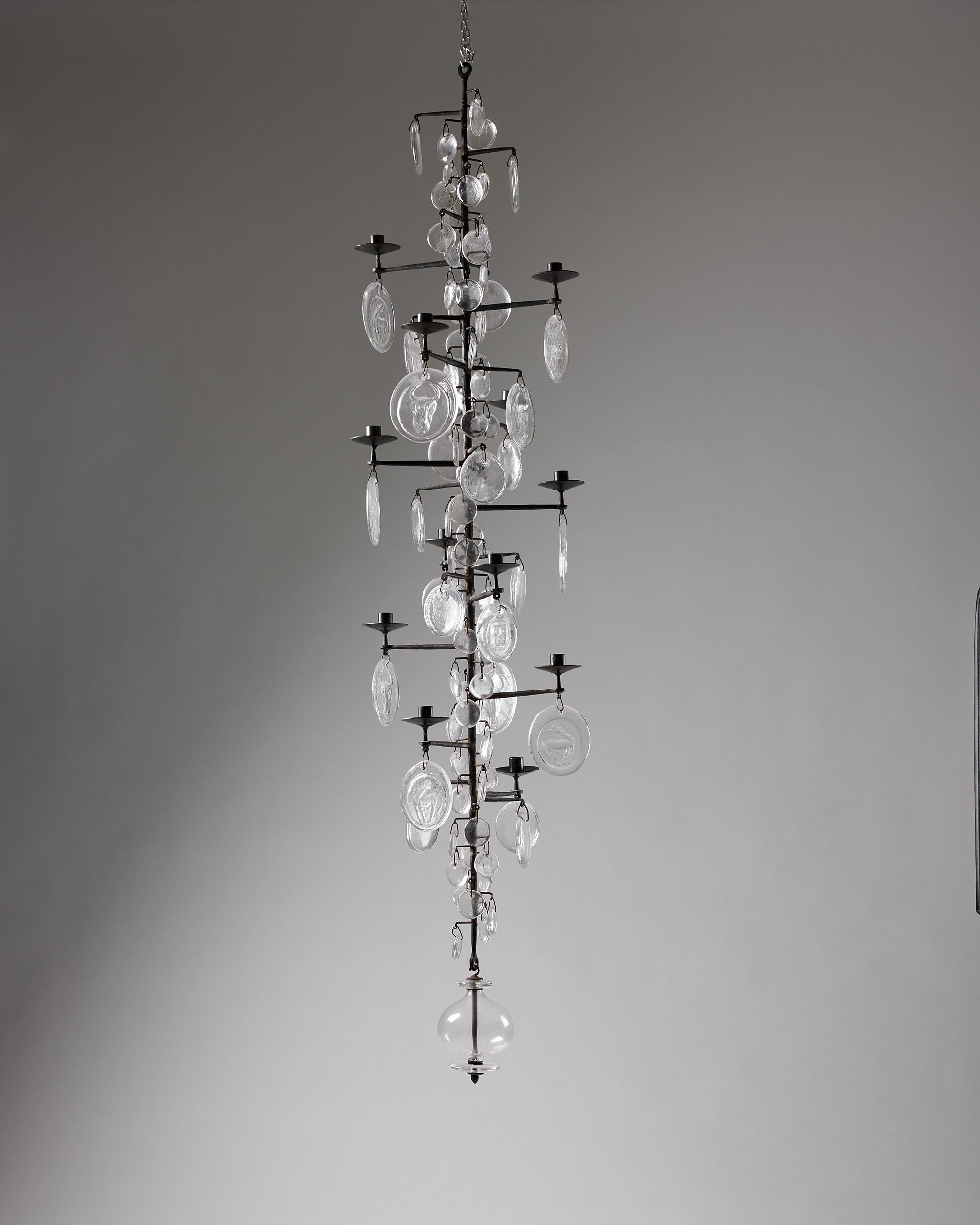 Chandelier model 341 designed by Erik Höglund for Boda,
Sweden, 1960s.

Wrought iron and glass.

Dimensions:
H: 170 cm / 5' 7''
Diameter: 40 cm / 15 3/4''