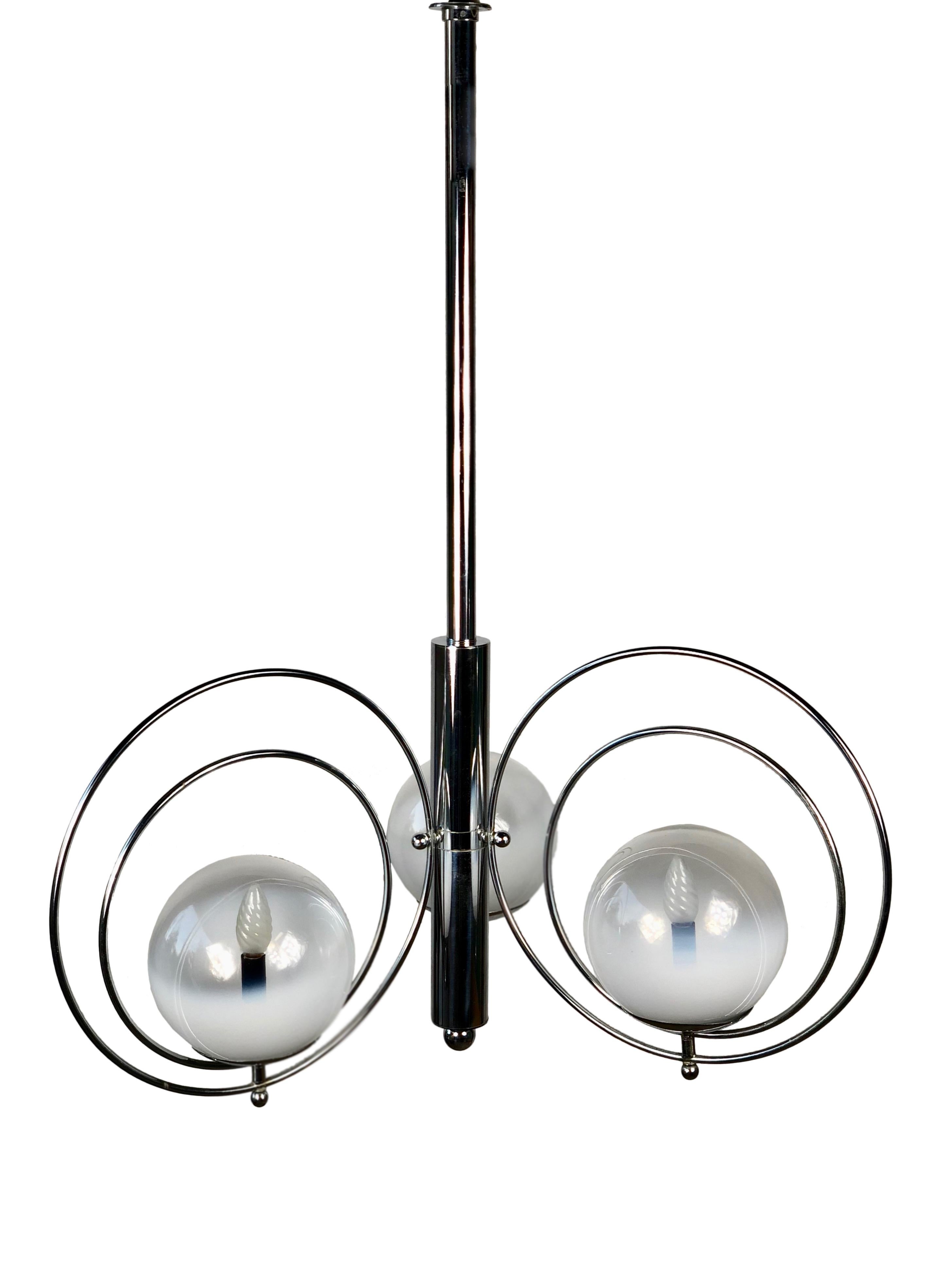 Chandelier featuring three Murano glass balls wrapped in two chrome rings with a chrome pendant. Beautiful and rare example of 1970s Italian design.