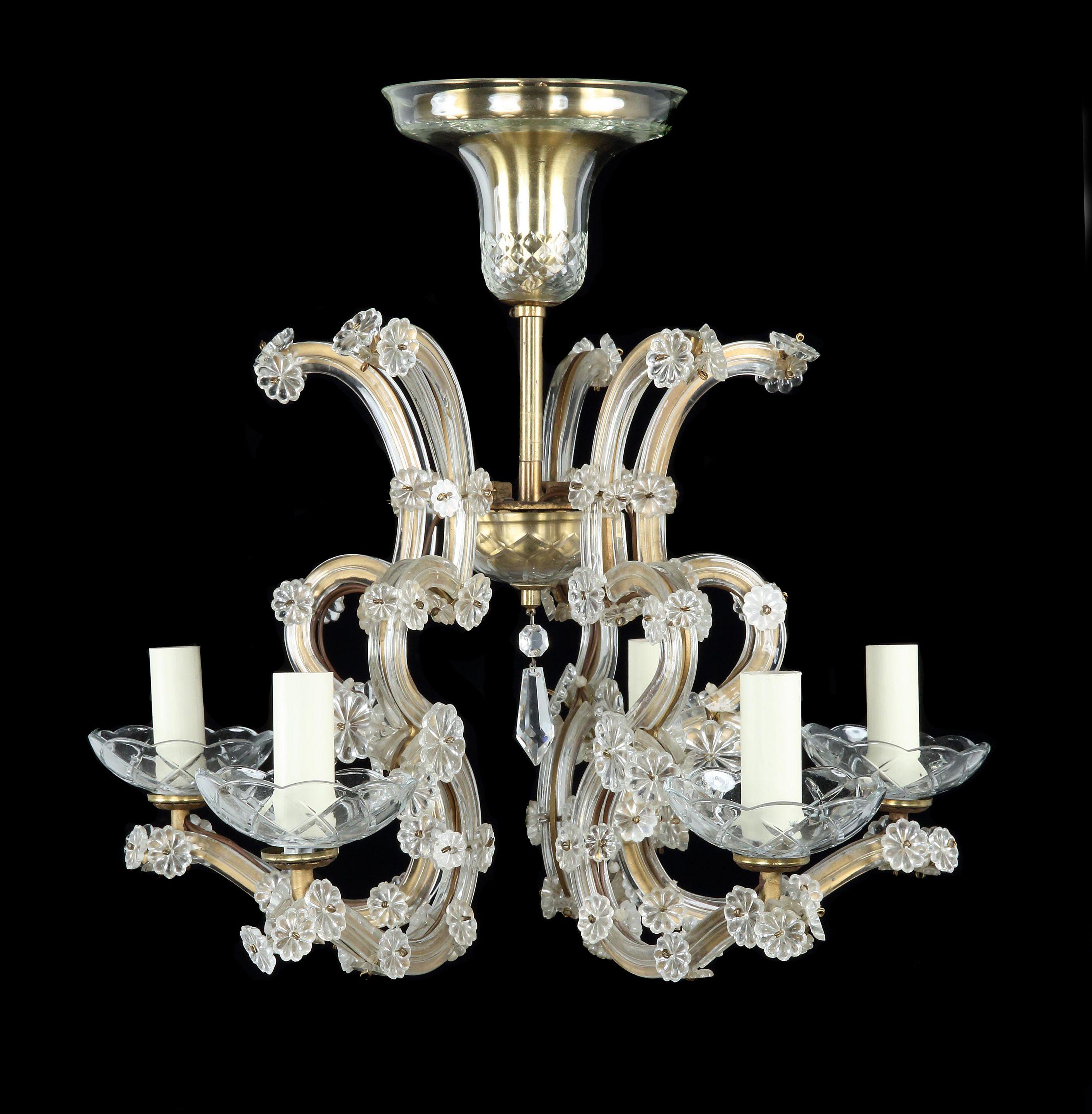 EDWARDIAN, 6-ARM, GILT-BRASS & GLASS CHANDELIER IN THE ROCOCO STYLE  17½ ” high

The lightness, elegance, and an exuberant use of curving and floral ornamentation are characteristic features of the Rococo period
The glass enhances the reflection of