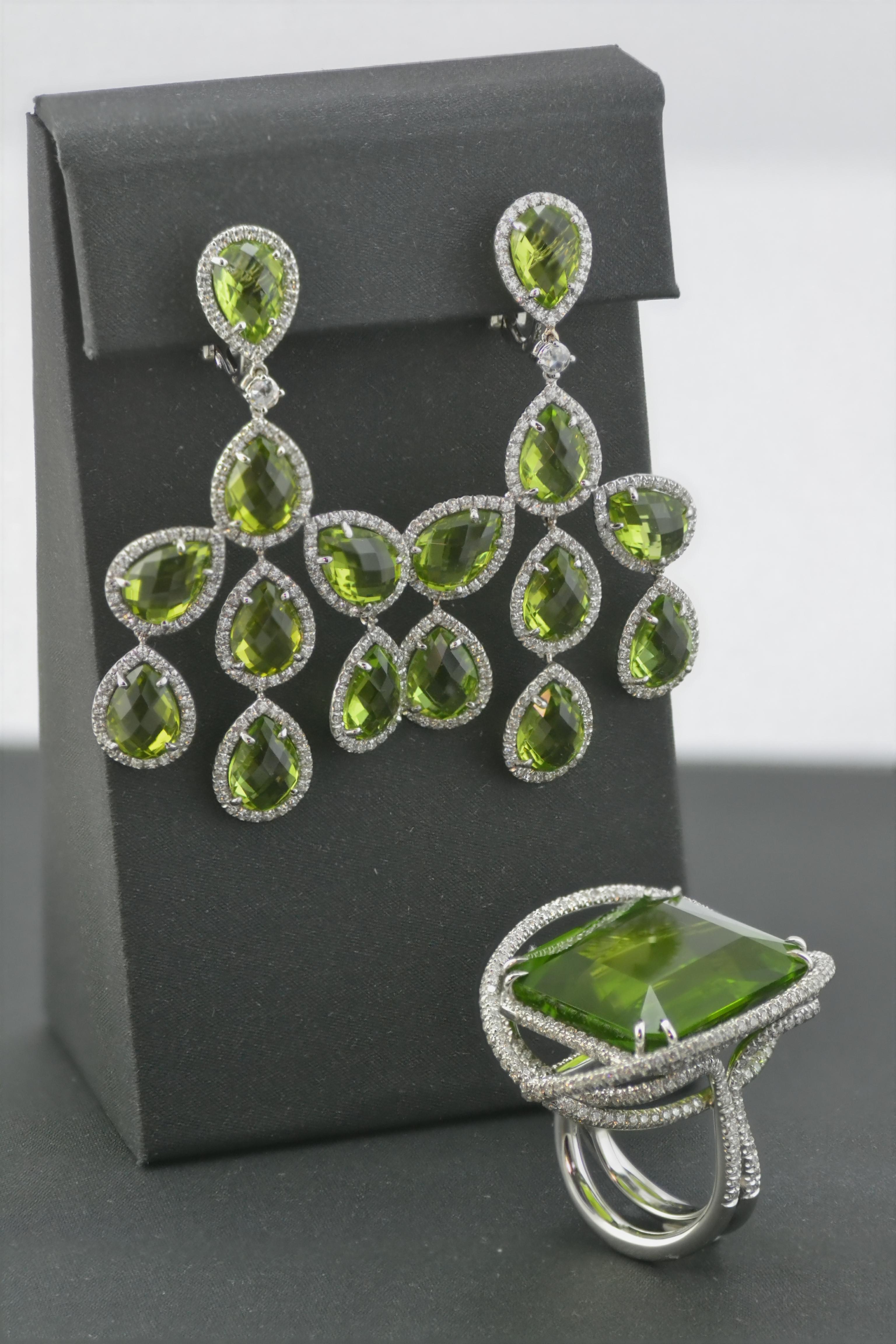 Vivid and brilliant chandelier earrings handcrafted in Italy in 18 kt white gold for a total of g 13,90 
they are set with number 368 diamonds for a total of  ct 2,06  and number 2 rose cut ct 0,12 - 
the briolette cut peridots are 16  for total