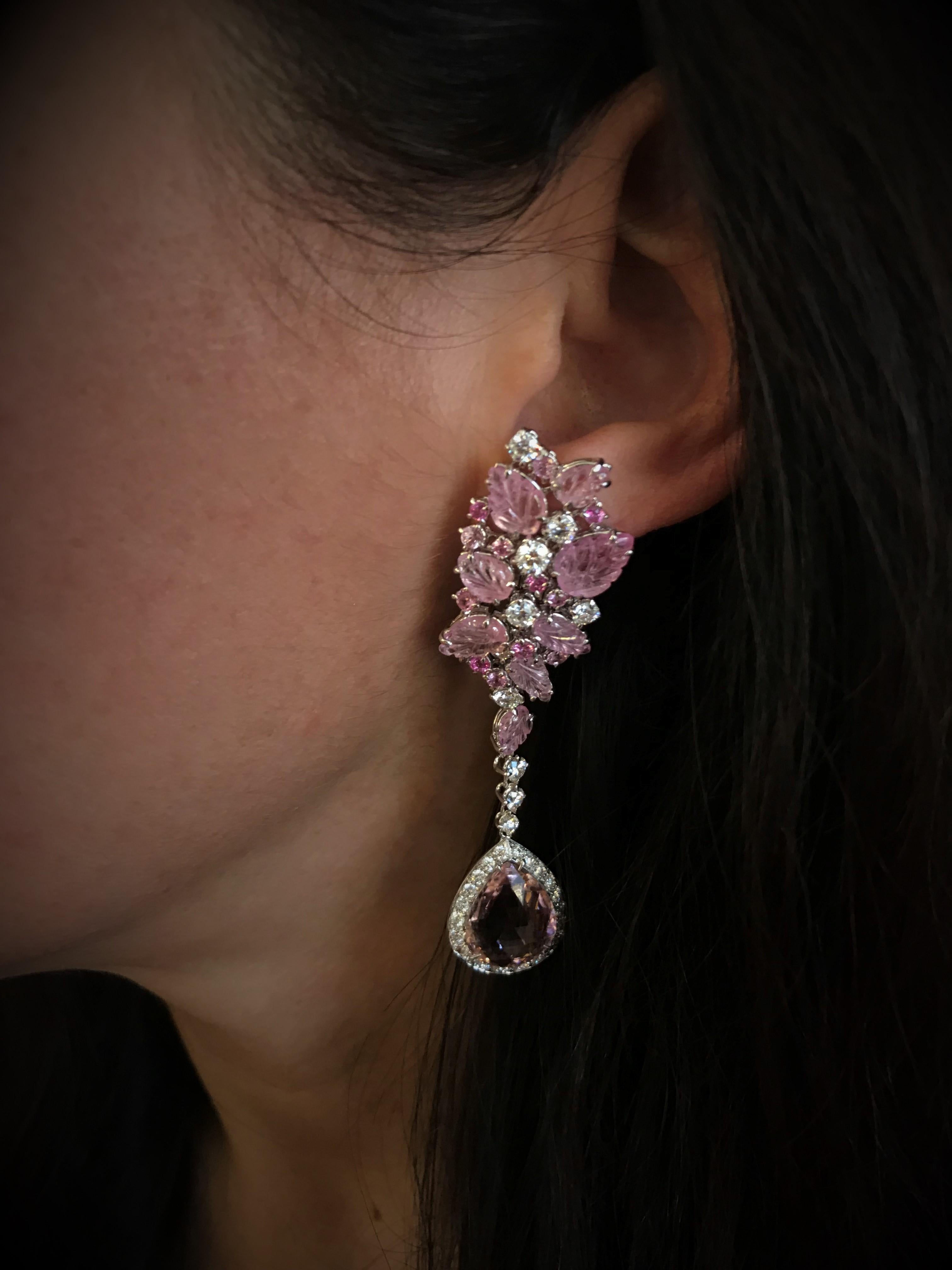Drop cut pink tourmaline is sustained by an elegant selection of carved pink tourmaline leaves.
White gold, diamonds pavé, round brilliant cut diamonds and pink sapphires, pink tourmaline drops and carved leaves of pink sapphires. 

Diamonds ct