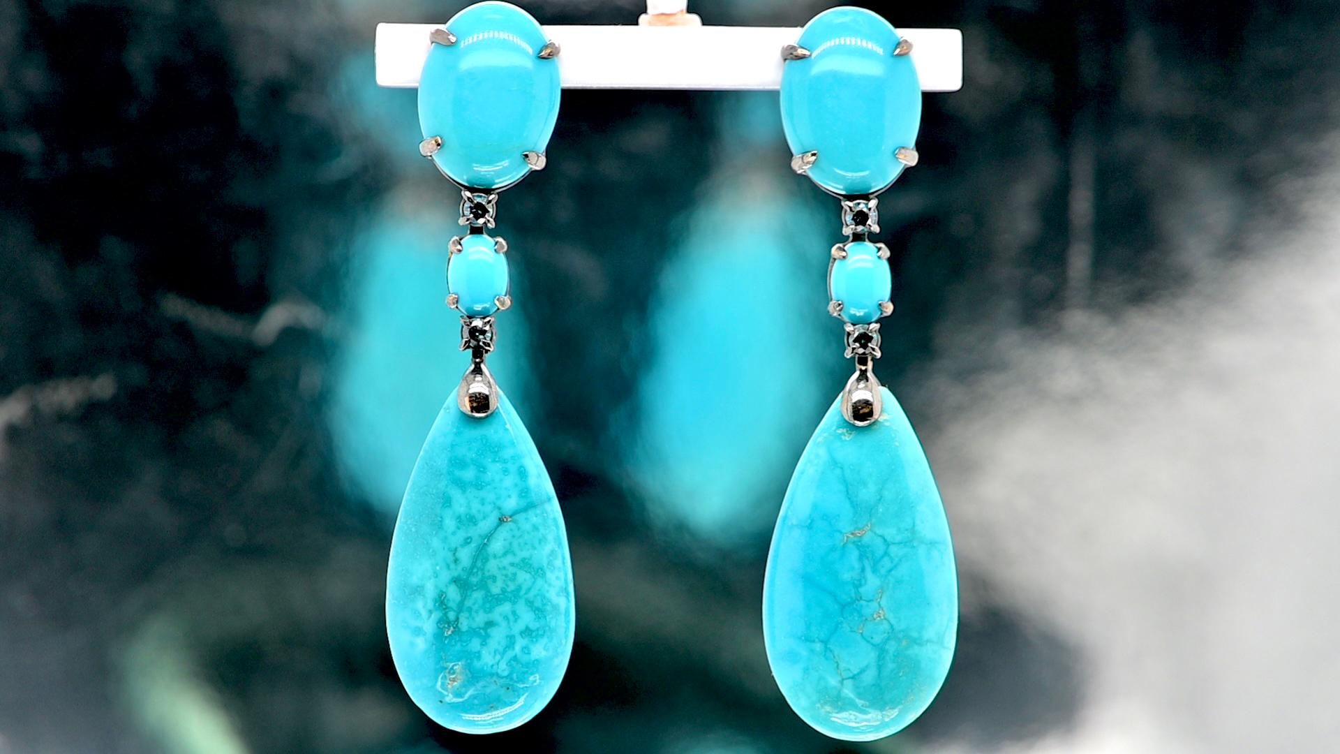 Immerse yourself in the sumptuous world of elegance with these magnificent chandelier earrings in black gold, sublimated by the sparkle of turquoise and the brilliance of blue sapphires. An exceptional piece of jewelry sure to seduce you with its