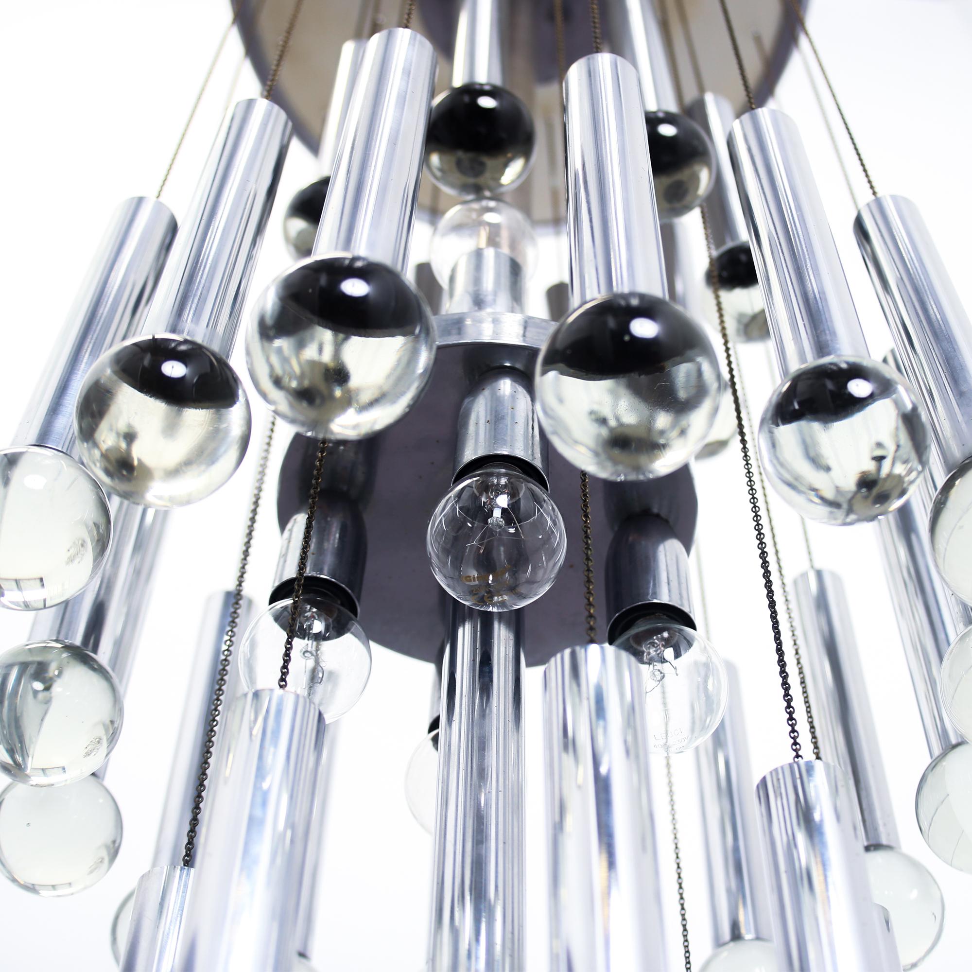 Gaetano Sciolari chandelier featuring three tiers of chrome cylinders and glass balls. Produced circa 1970, Italy.
 