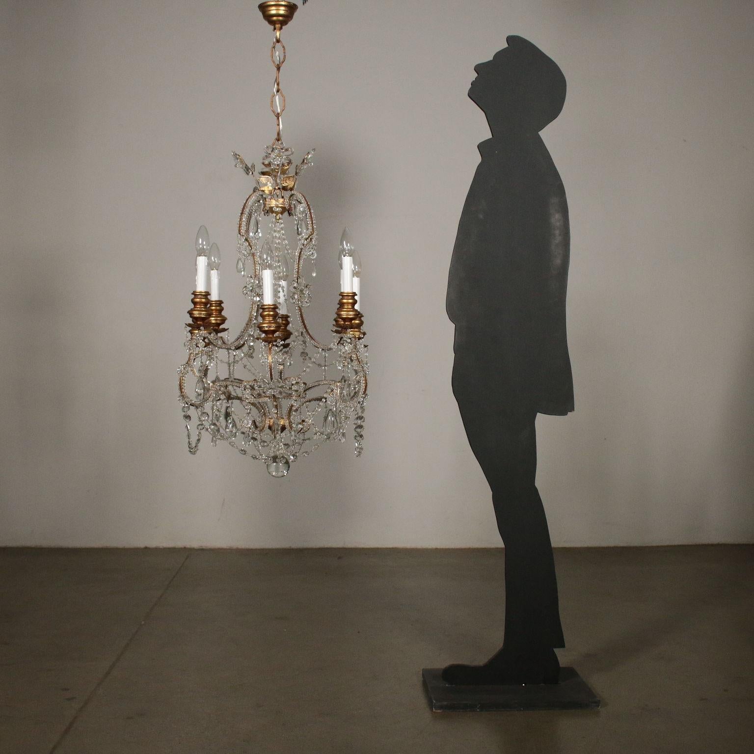 Chandelier with eight arms made of gilded iron with glass ropes and gilded wood support. Glass flowers and pendants. Manufactured in Italy, 20th century.