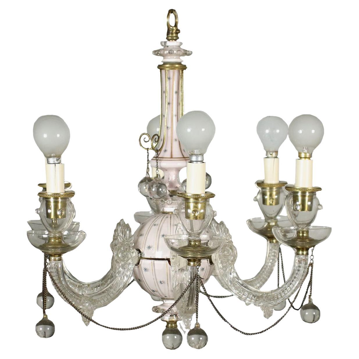 English painted glass chandelier. The central body is turned in the upper part, taking the shape of a sphere in the lower one. The thick glass is back-painted in pink, while the outermost part is adorned with small stars, also painted in blue, and