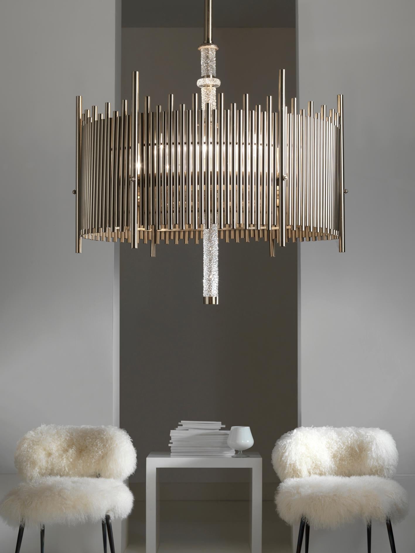 Chandelier with hand worked brass castings in brushed nickel finish and hand faceted crystal details.
With 12 lights.