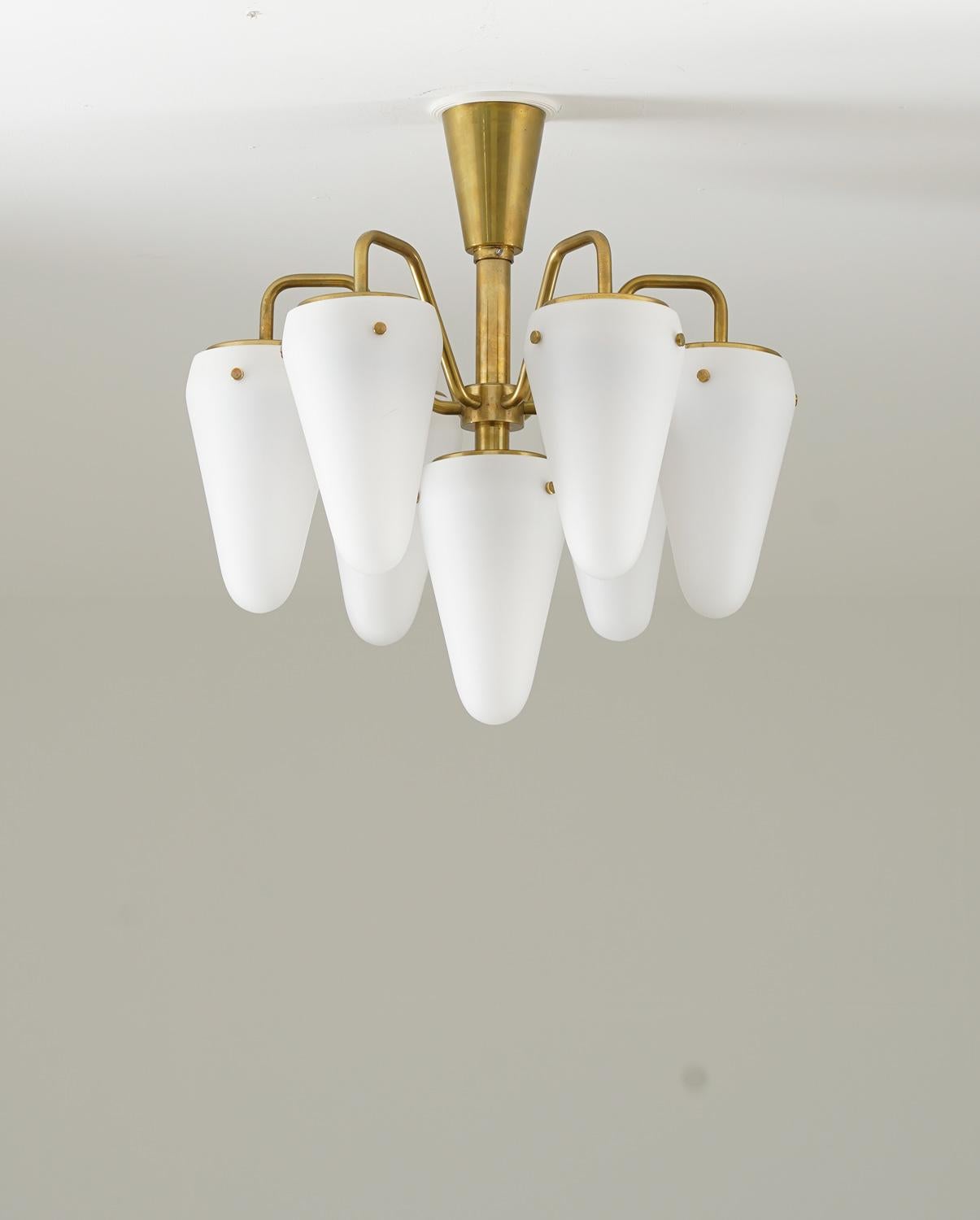 Rare midcentury chandelier in brass and frosted opaline glass, by Hans-Agne Jakobsson, 1950s. 
This early Hans-Agne Jakobsson chandelier is made with a high sense of quality and has great details. It features seven light sources, hidden by