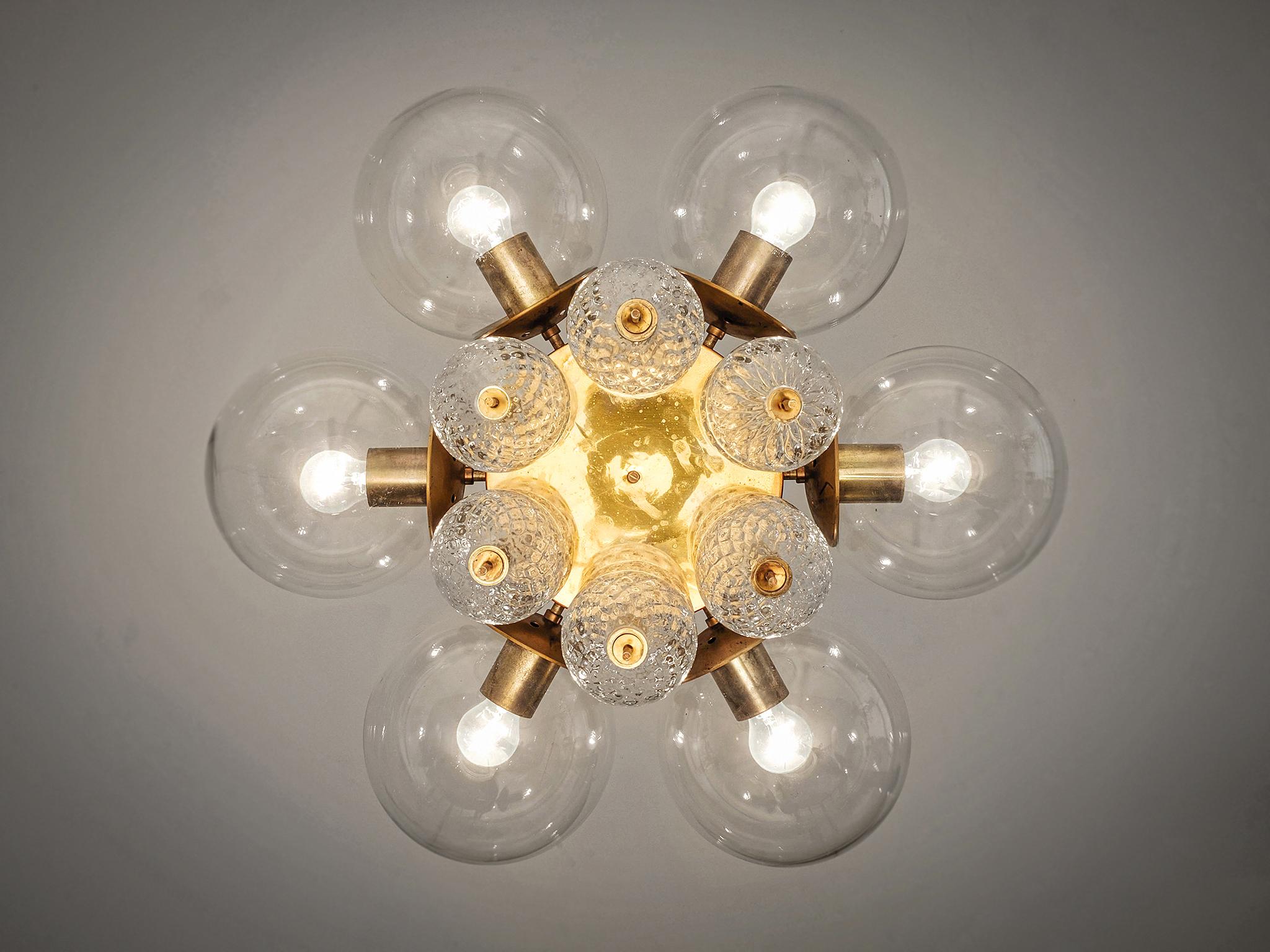 Chandelier, brass, glass, Europe, 1960s.

Elegant chandelier with brass fixture and structured glass decoration. With six light-points, the chandelier creates a nice warm light. The structured glass and brass emphasize to the great light partition