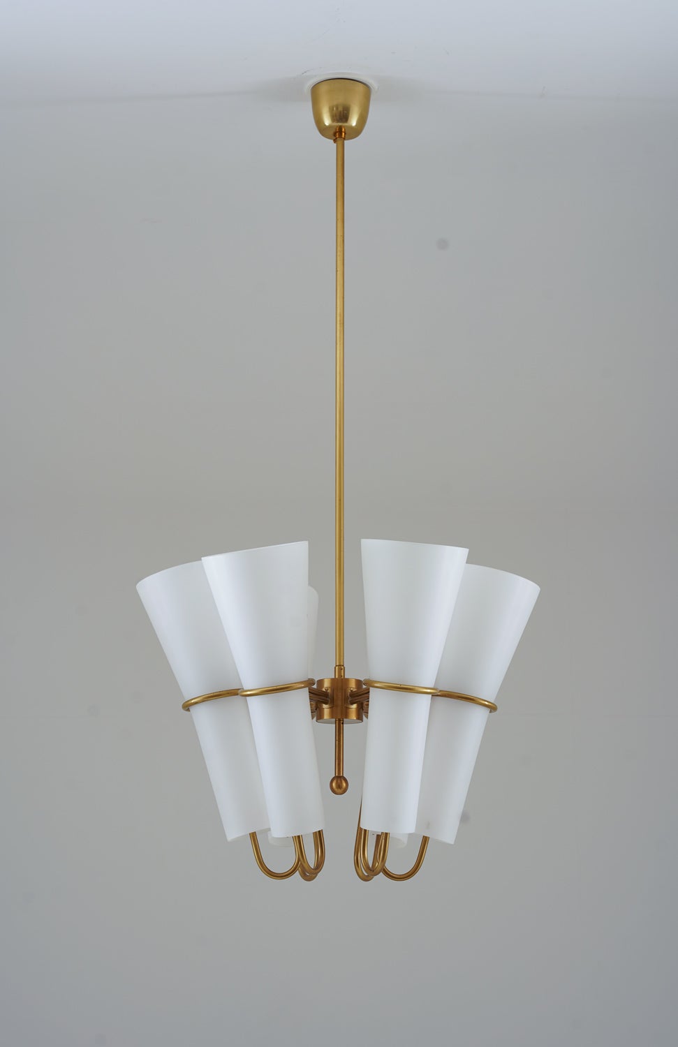 Very rare chandeliers by Hans-Agne Jakobsson, manufactured by Arnold Wiig Fabrikker, Norway.
These magestic lamps feature six light sources, hidden by large opaline glass shades. The shades are held by a brass frame.

The shades’ height is 40cm