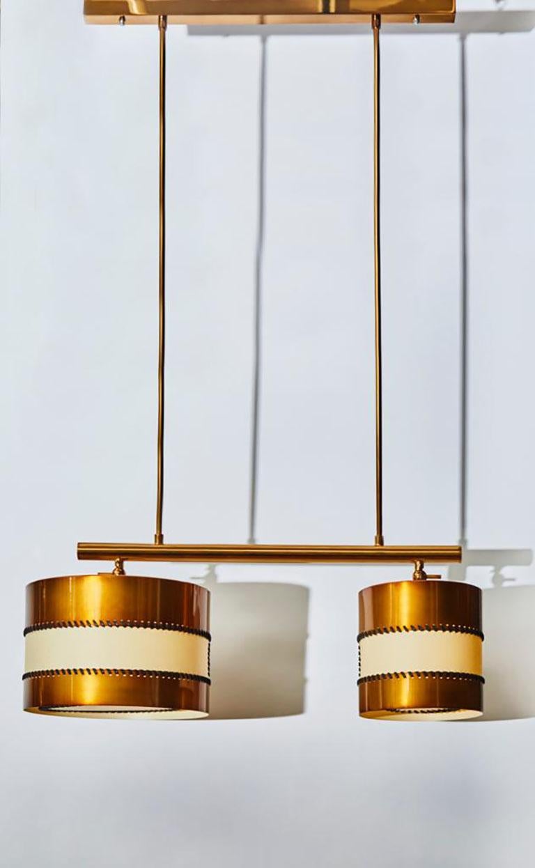 New design by Diego Mardegan exclusively for Glustin Luminaires, Dedalo chandelier made of two brass and parchment paper drums that can be adjusted invidually. Hung by a pure and simple structure in this beautiful patina between bronze and copper.
