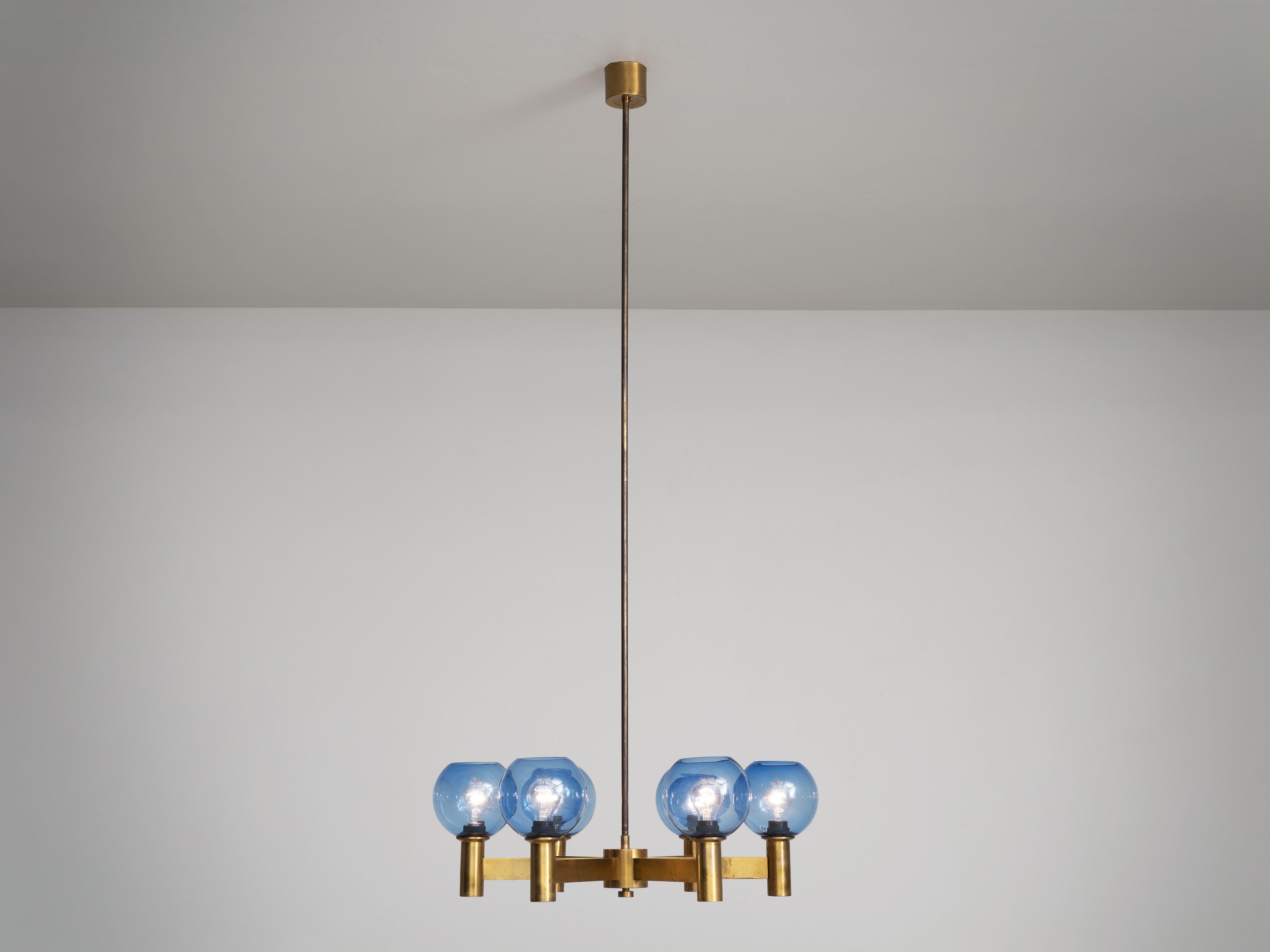 Chandelier, glass, brass, Sweden, 1960s. 

Chandelier in patinated brass with blue colored glass shades. Divided over six arms this light will create a stunning light partition. The blue glass spheres will create and even more interesting light. Due