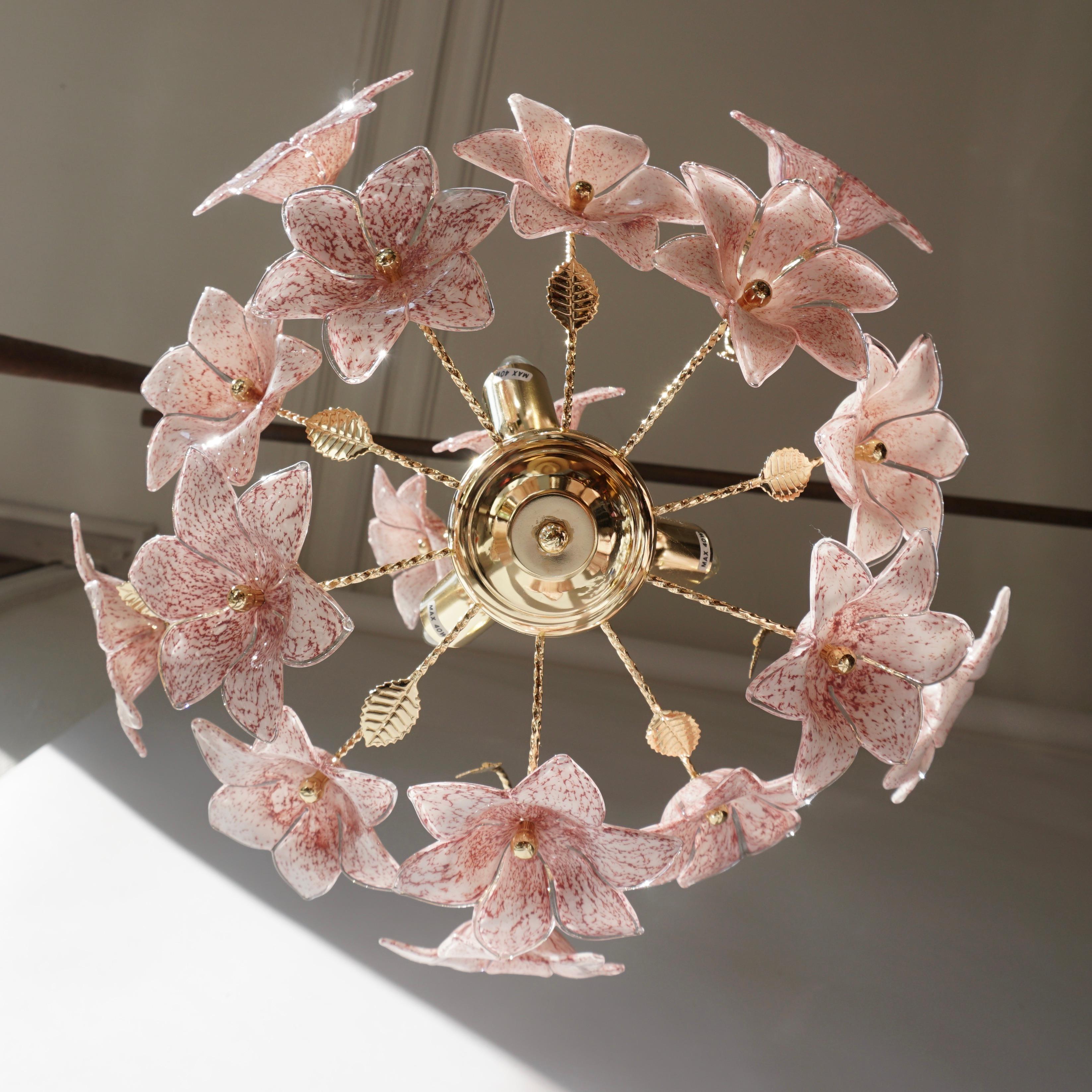 Italian brass chandelier with pink Murano glass flowers and brass leaves. 

The light requires three single E14 screw fit light bulbs (40Watt max.) LED compatible.

Measures: Diameter 40 cm. 
Height fixture 44 cm.
Total height with chain 75 cm.