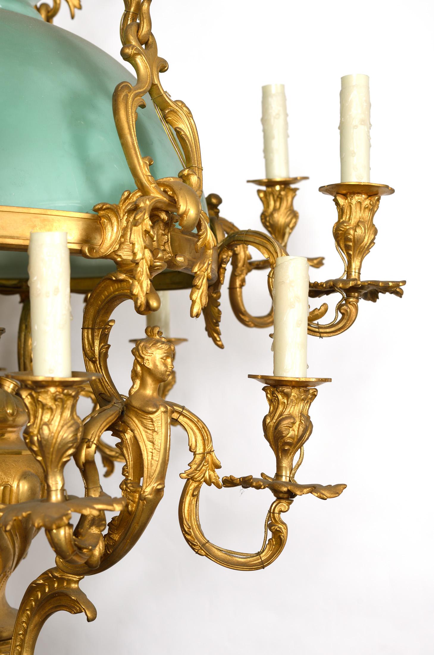 A very rare chandelier in gilt bronze with an original green opaline and figurine 
which hold the branches, plus you have a light that illuminate the opaline in the middle.