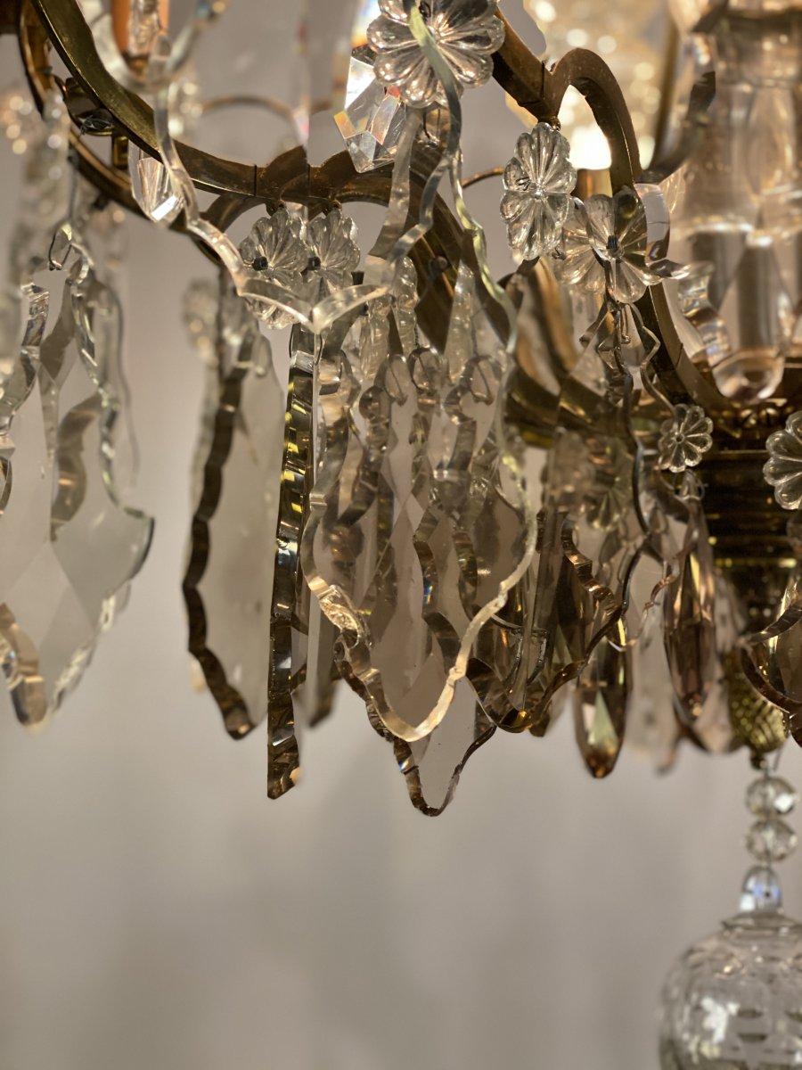 Chandelier in gilded bronze, 9 sconces and three crystal daggers. transparent and golden tassels.