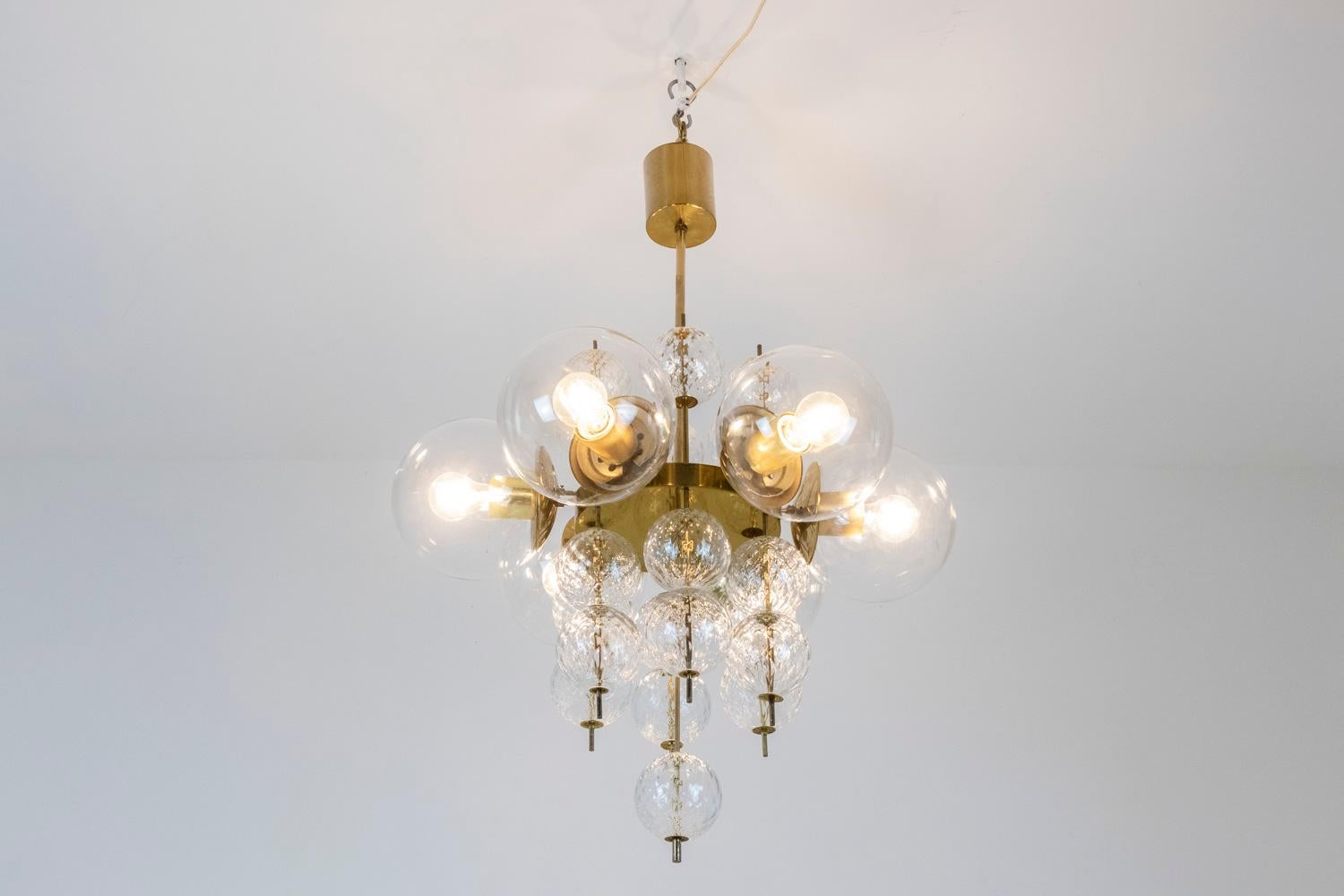 Six-light chandelier. Blown glass balls, transparent for the six sconces and with a checkered decoration for those that are decorative. Golden brass frame.

Italian work realized in the 1970s.

Three pieces available!