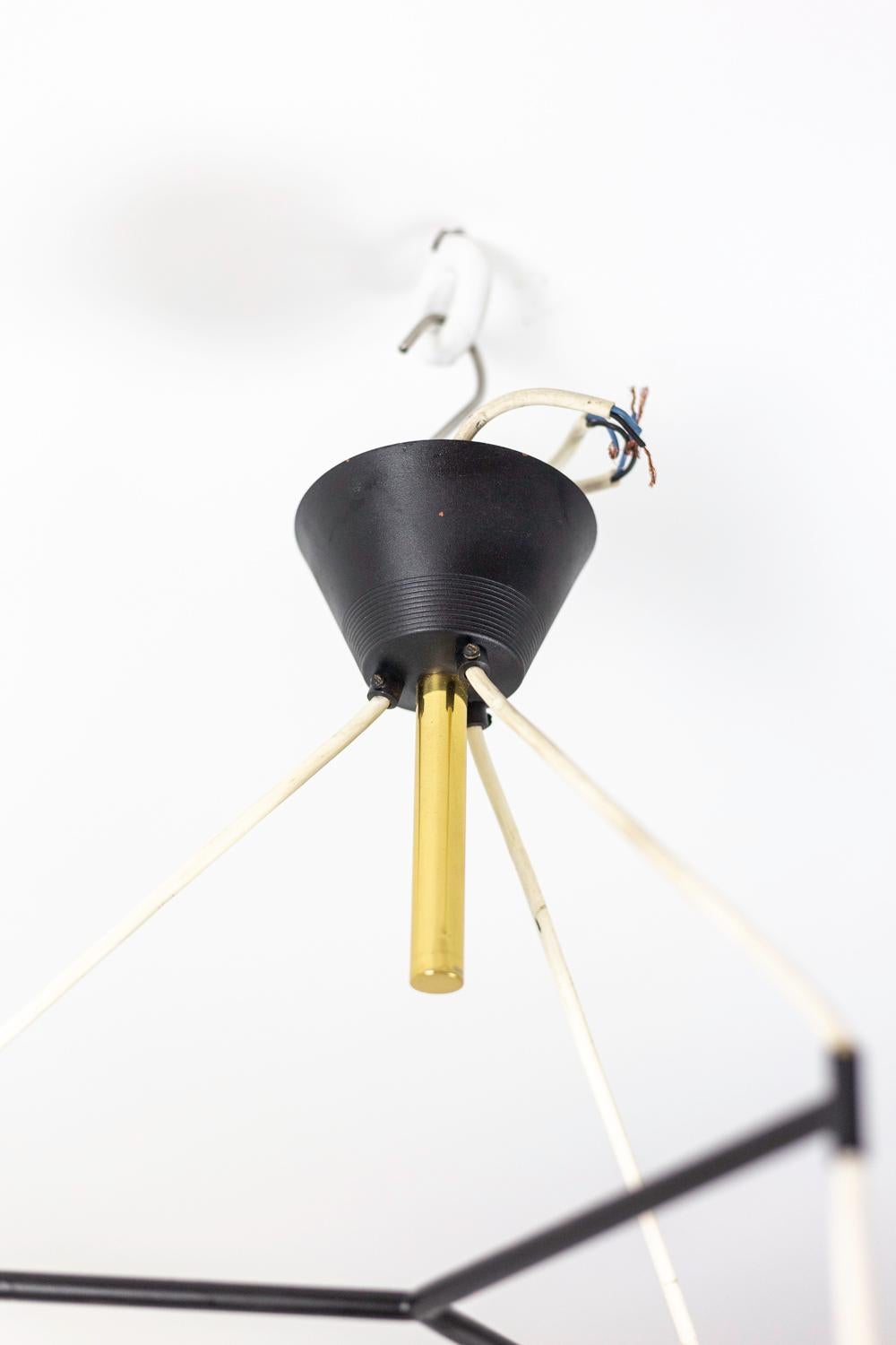 Chandelier in granite resin and gilt brass with three-light. Cache-bélière (hide hook) in black Lucite with a small gilt brass tube where three white wires leave, separated by a tripod branch. Circular lampshades in resin topped by gilt brass tubes