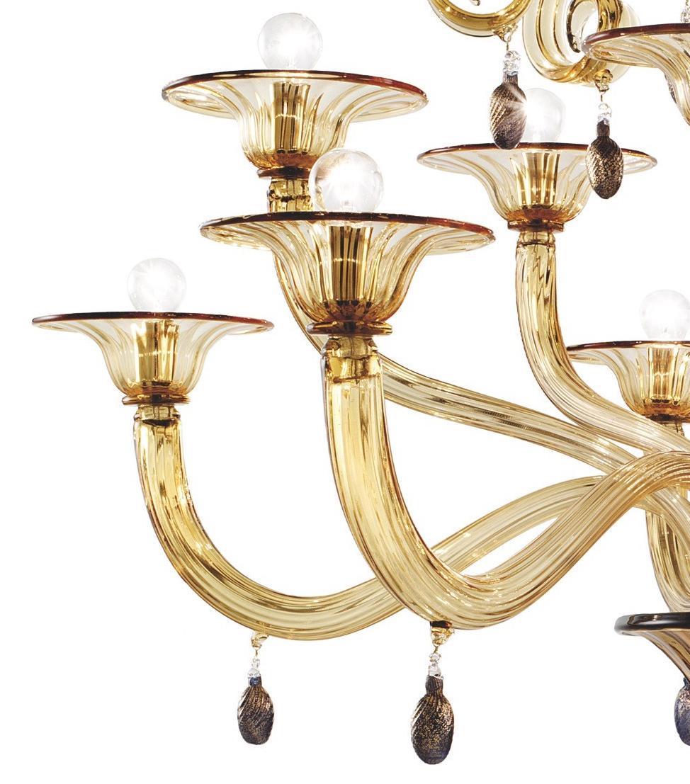 This big Murano Glass twelve lights chandelier was designed by Napoleone Martinuzzi in 1926, that was an Italian artist active in Venice as director of Murano Glass Museum from 1922 to 1933. The same chandelier was ordered by the poet Gabriele