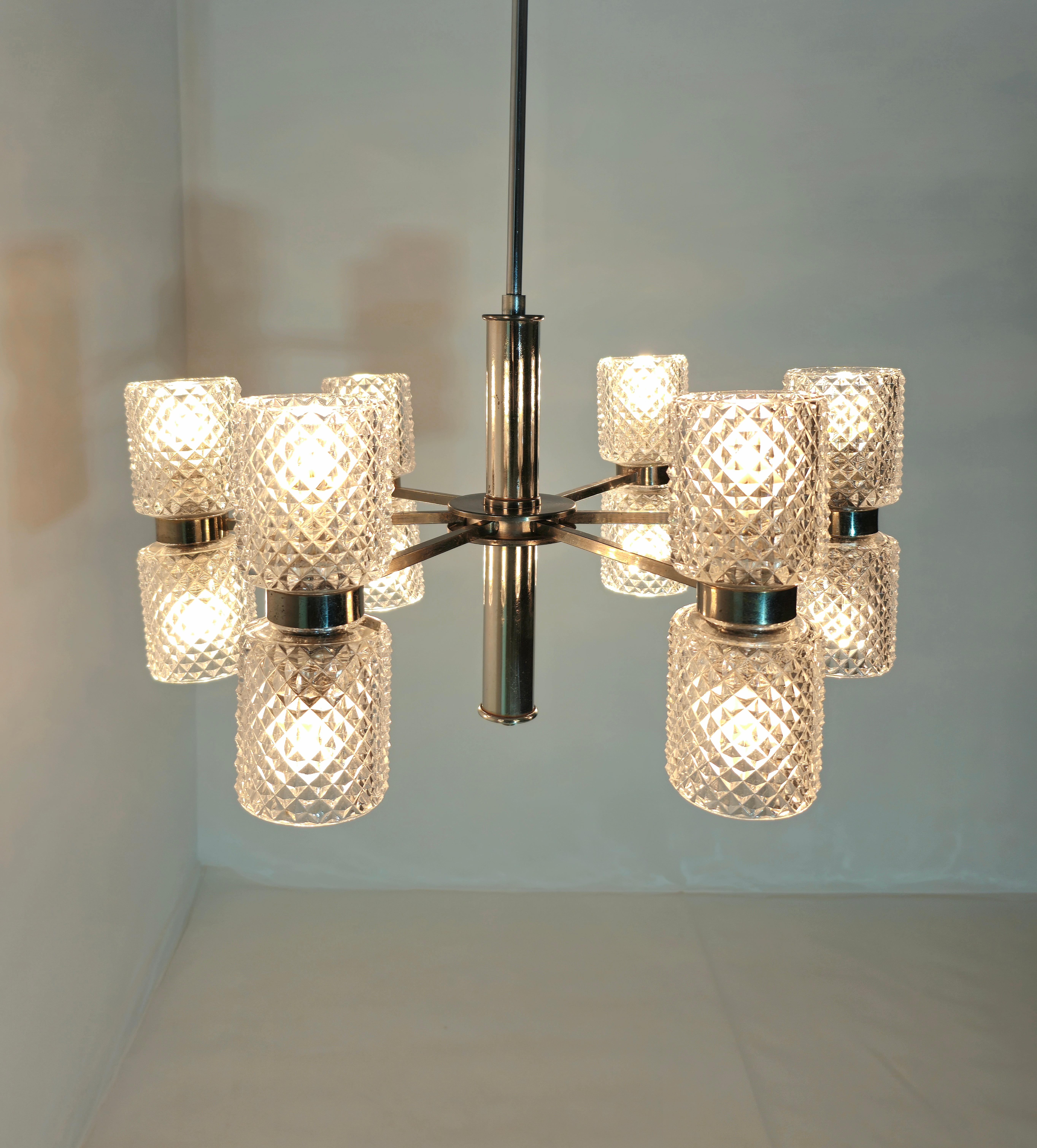 Very elegant 12-light chandelier with Bohemia crystal glasses. Nickel-plated brass structure with six arms. Each arm has two glasses, one that distributes the light upwards and the other with light directed downwards. Truly one of a kind. Production