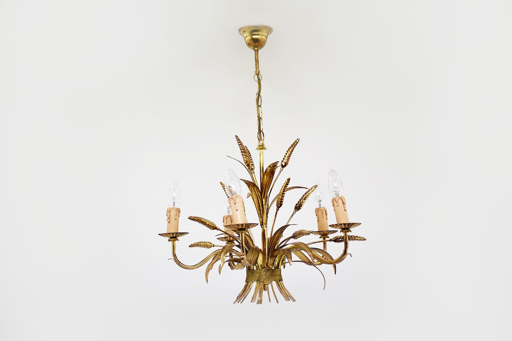 This pendant has been made in France, circa 1960. It is in the Hollywood Regency style, the five wheat shaped lights are in guilt metal. It remind the productions of Maison Jansen. Coco chanel has been used this wheat model for a table where she