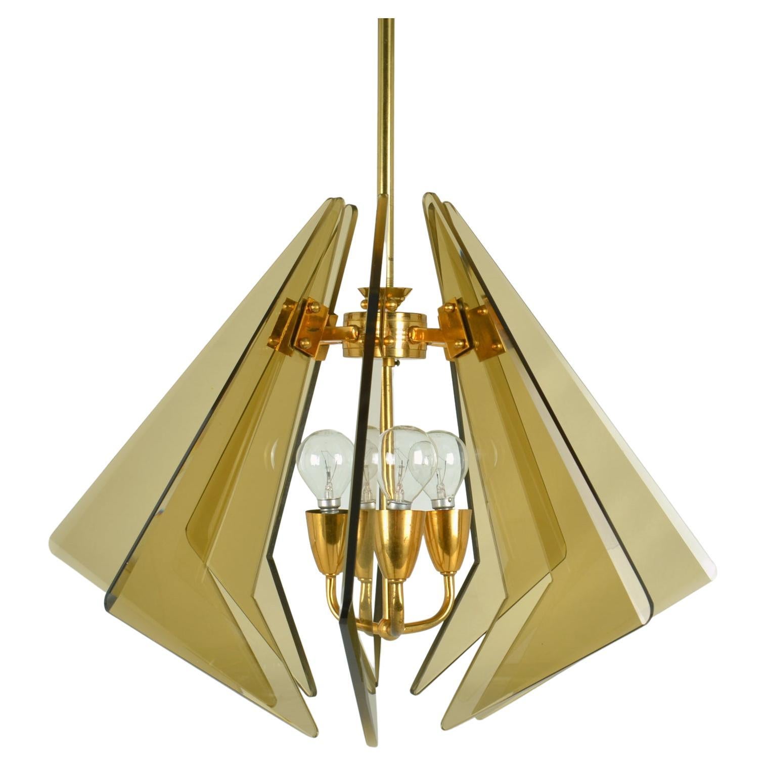 Fontana Arte glass diamond shaped chandelier consists of eight triangular pieces of tinted and faceted hand cut glass. They have been positioned vertically that radiate around a gilded brass frame. The lamp is attributed to Gino Paroldo who designed