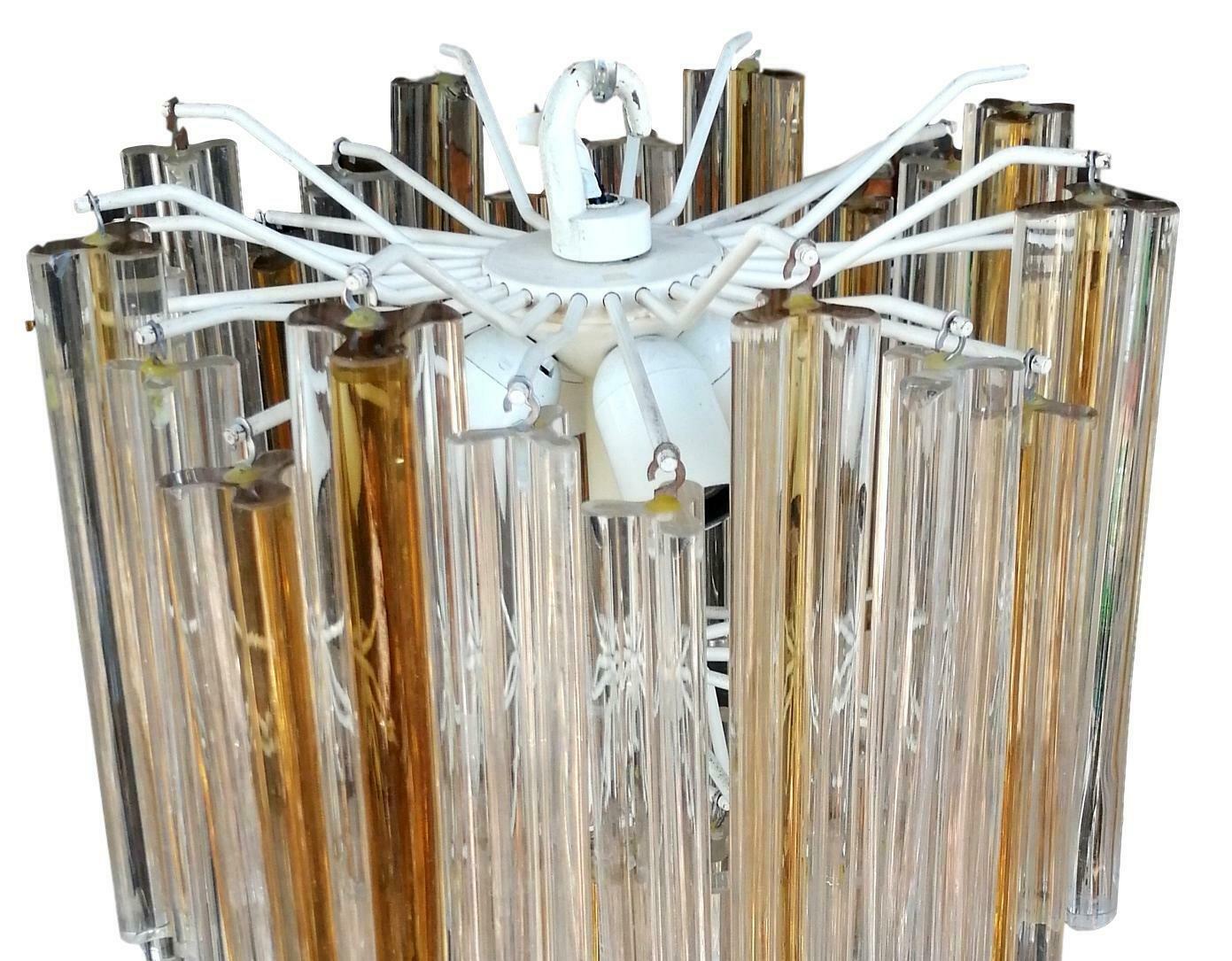 Splendid original venini 60s chandelier, a cascade of trefoil glass of mixed shades of amber and white arranged on several levels, elegant, harmonious, timeless

overall height just under 70 centimeters, carefully and scrupulously preserved, in